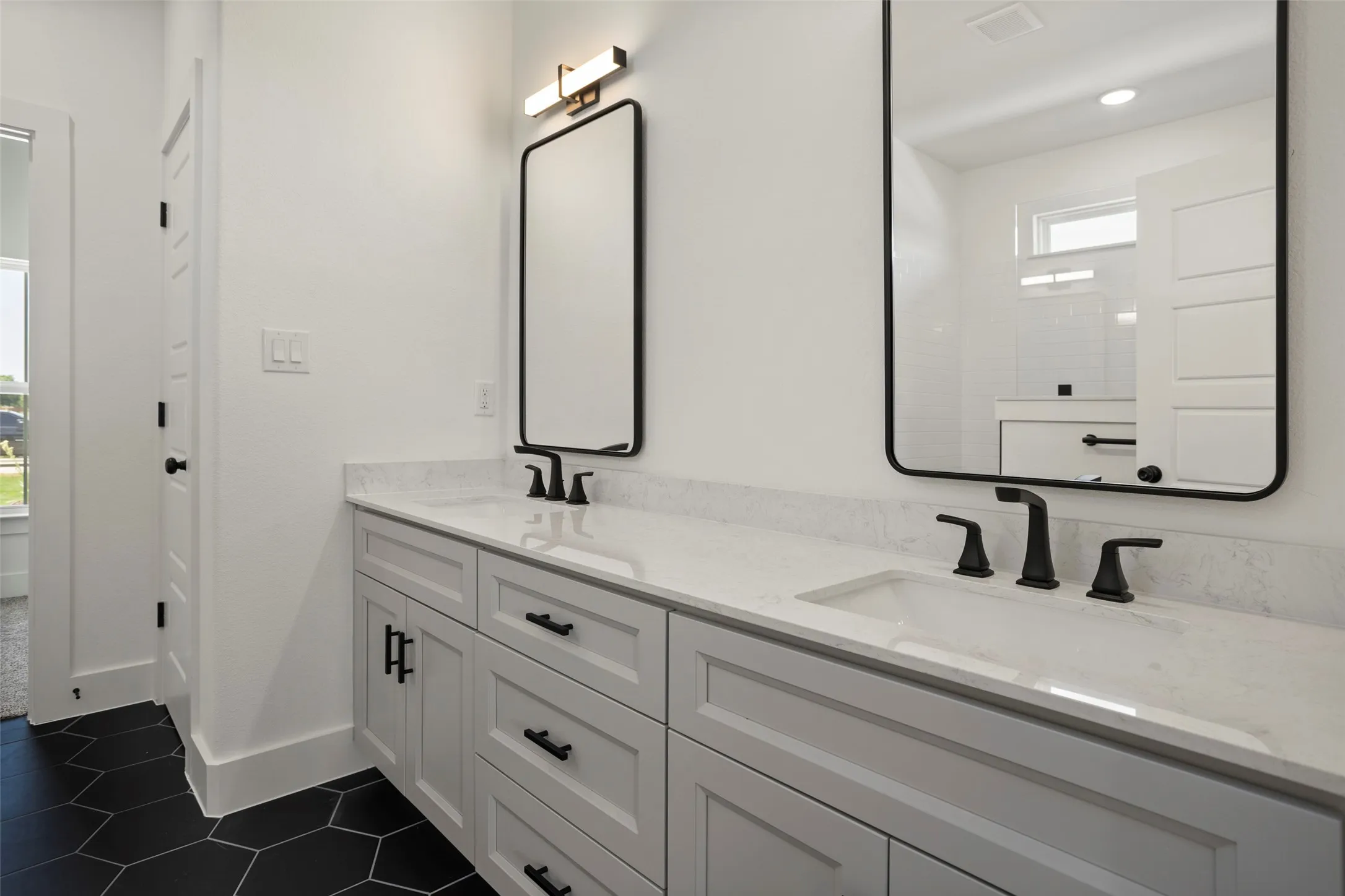 Bathroom featuring tile patterned flooring and dual bowl vanity