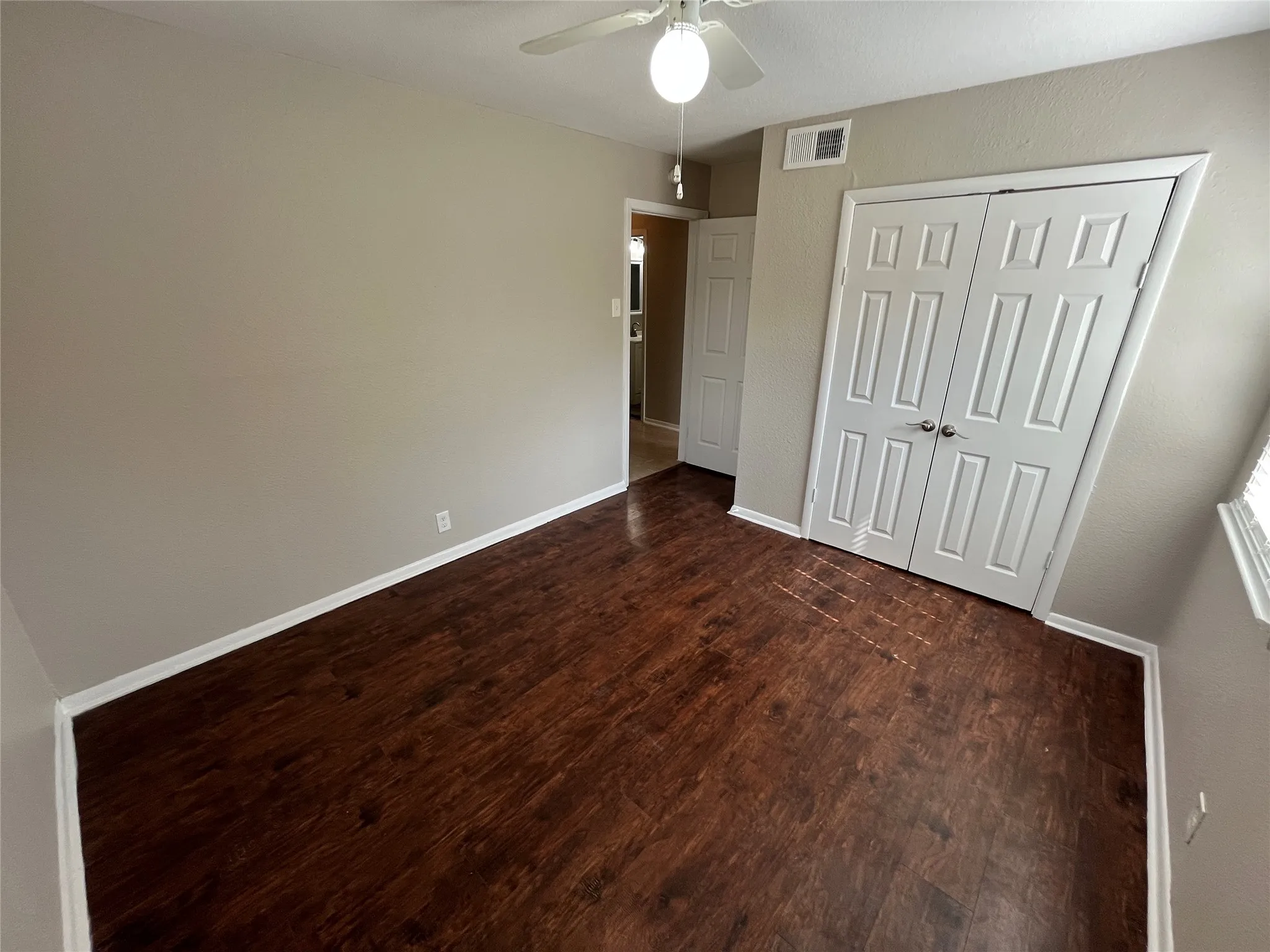 Wood-finish flooring with white baseboards