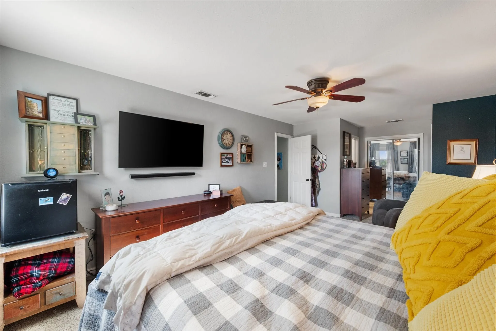 Ceiling fan light fixture, sliding glass door, interior door, wall-mounted television, wall-mounted soundbar