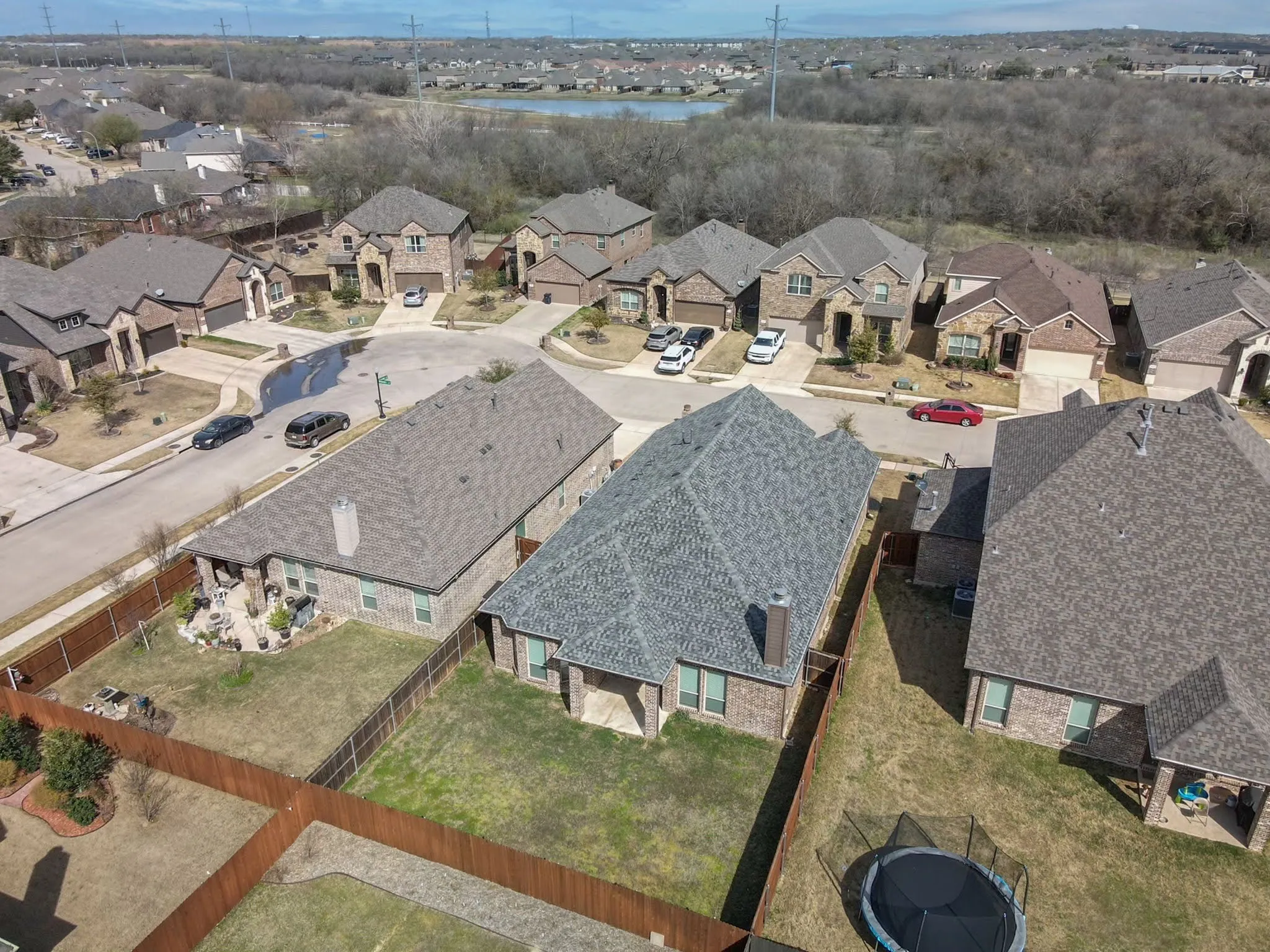 Residential neighborhood featuring mature trees and a distant body of water