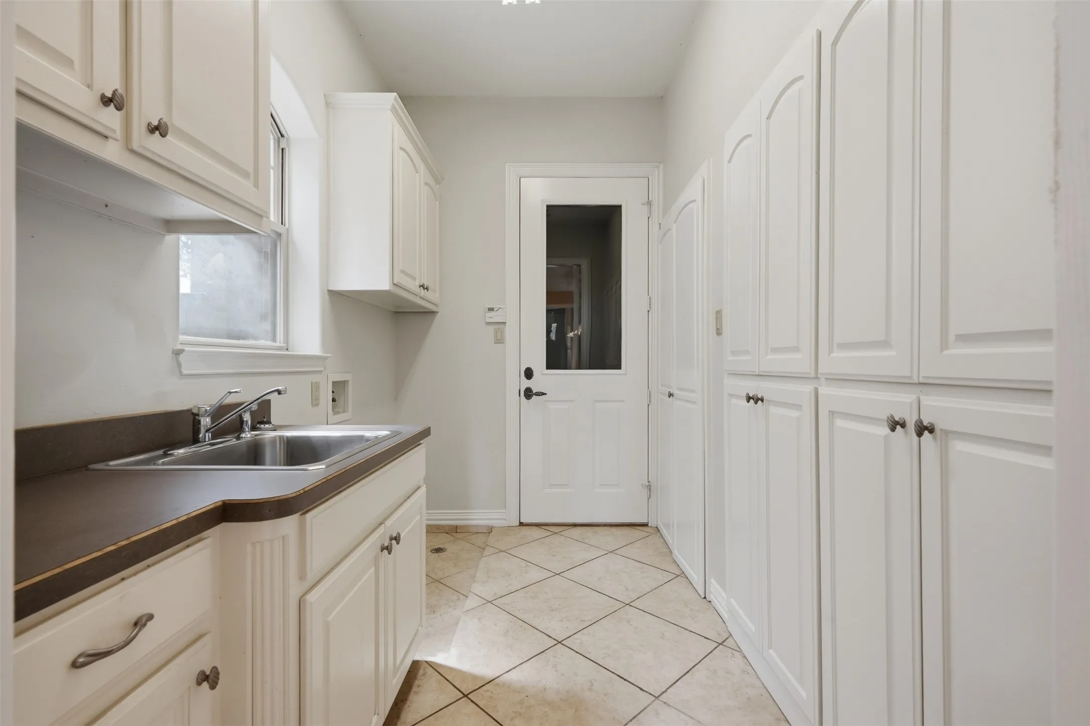 Oversized laundry room with sink and tons of storage