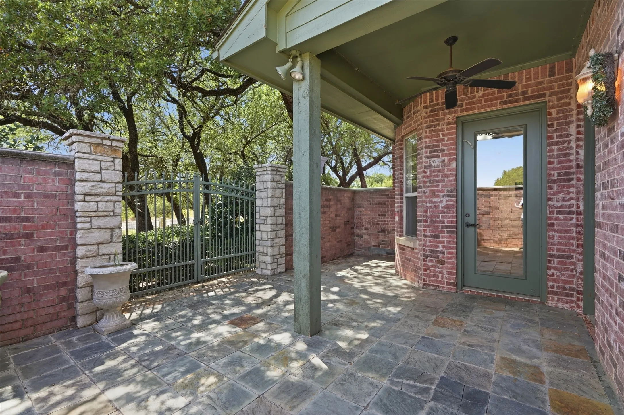 Beautiful outdoor space with covered porch and fan