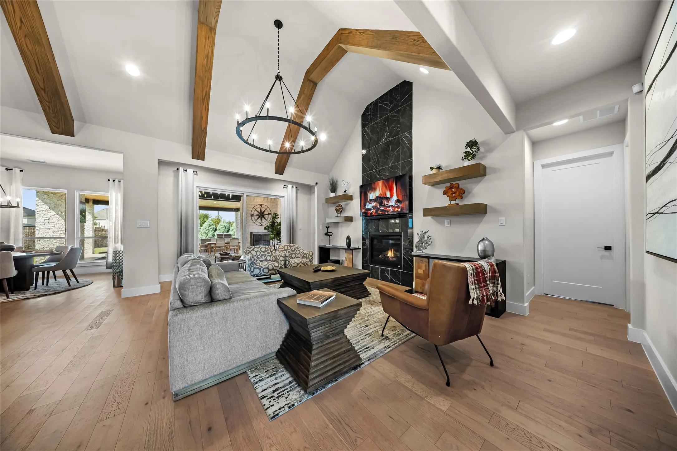 Vaulted ceiling with exposed wood beams and chandelier