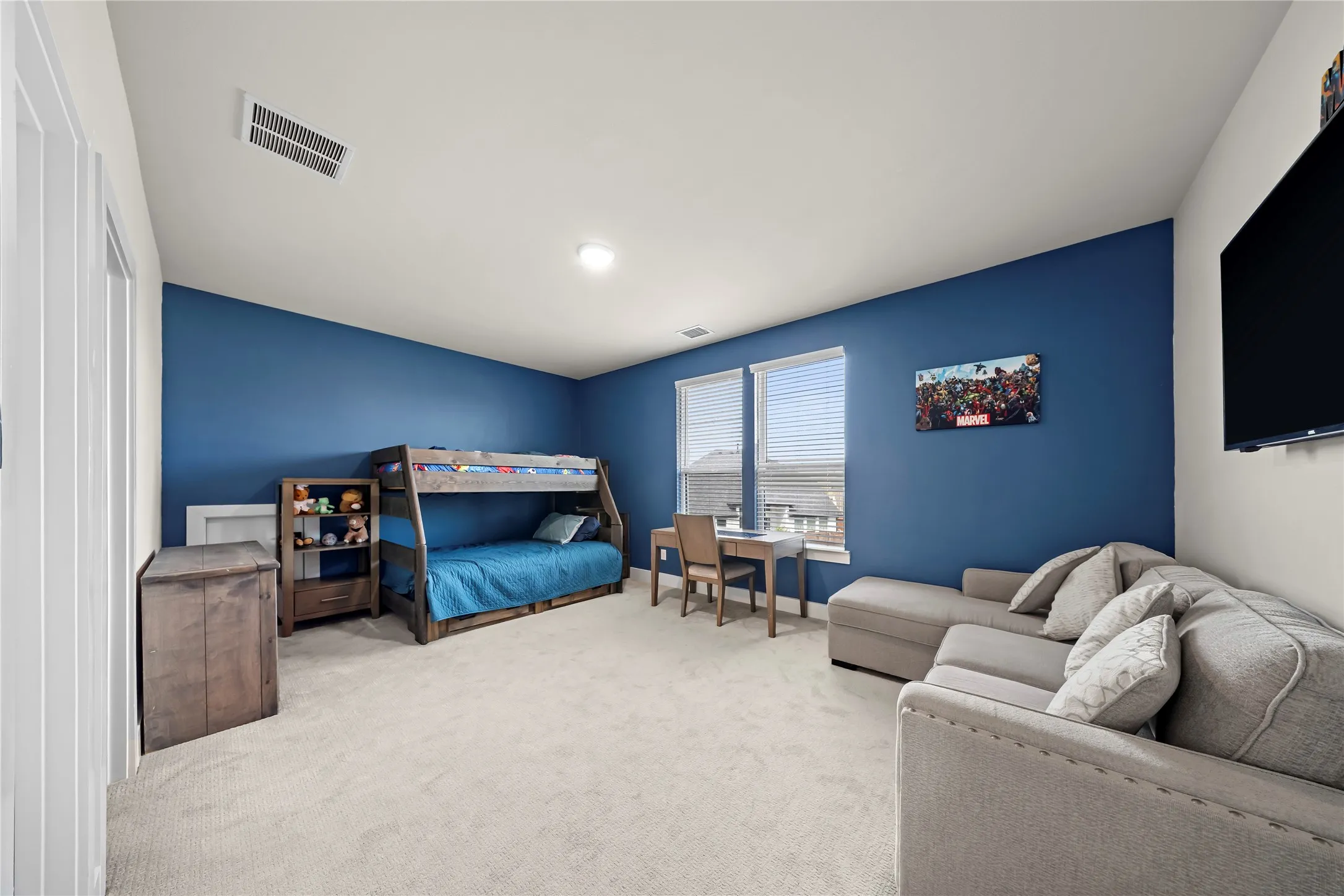 Recessed ceiling lighting, multiple windows with blinds, and light-toned carpeting