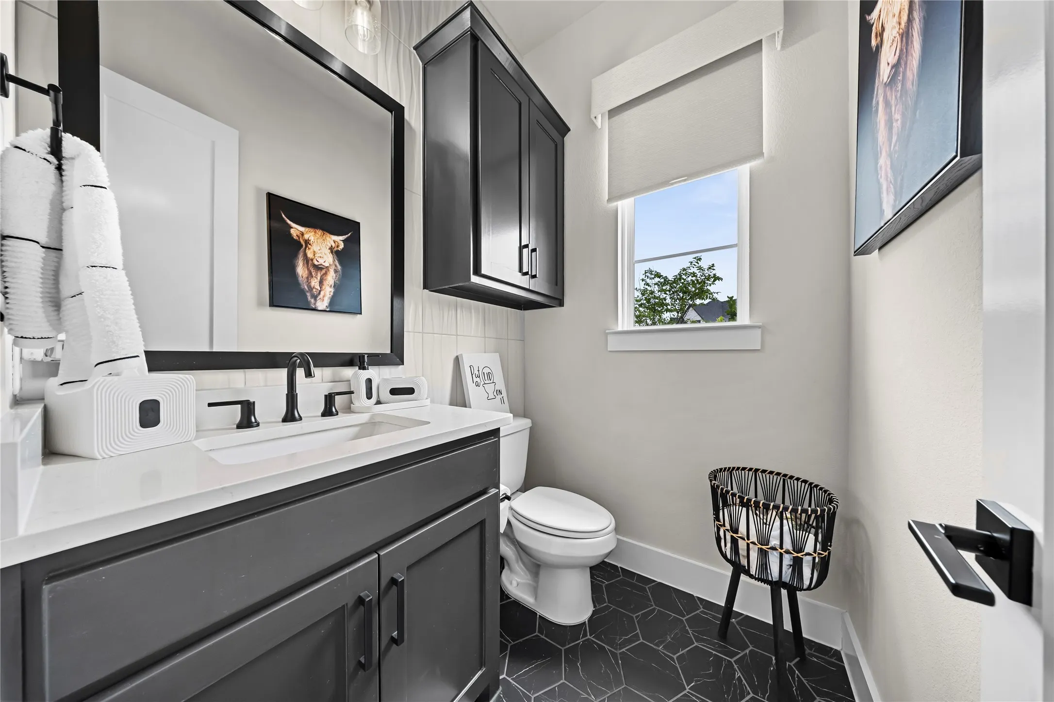 Vanity with an integrated sink, quartz-finish countertop, and matte black hardware