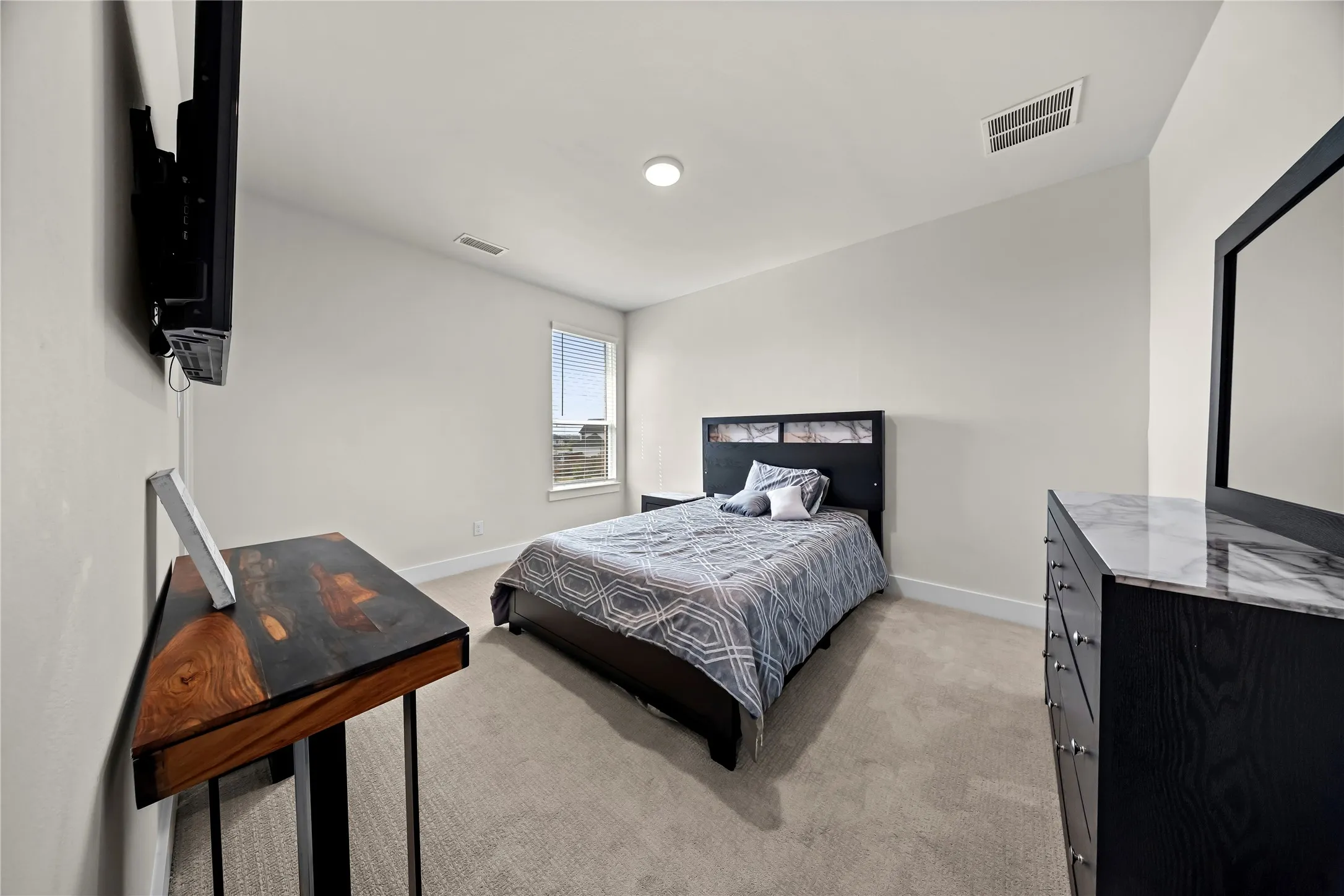Plush carpeting, recessed lighting, and a window with blinds