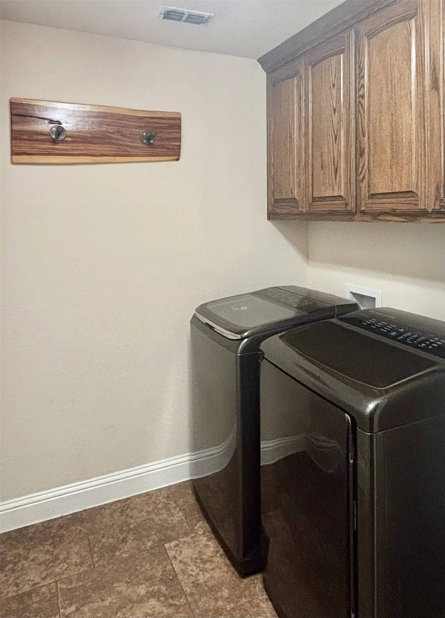 Upper cabinetry with wood-finish doors and crown molding