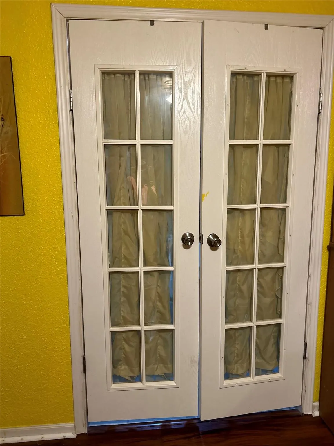 Double French doors with clear glass panes and polished chrome hardware