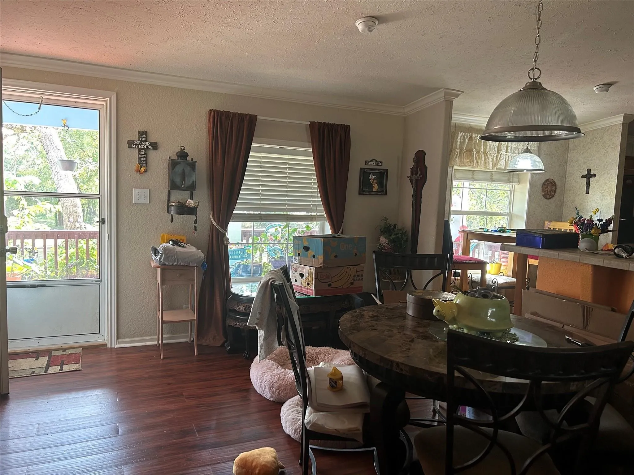 Wood-finish flooring, white trim, and a white screen door