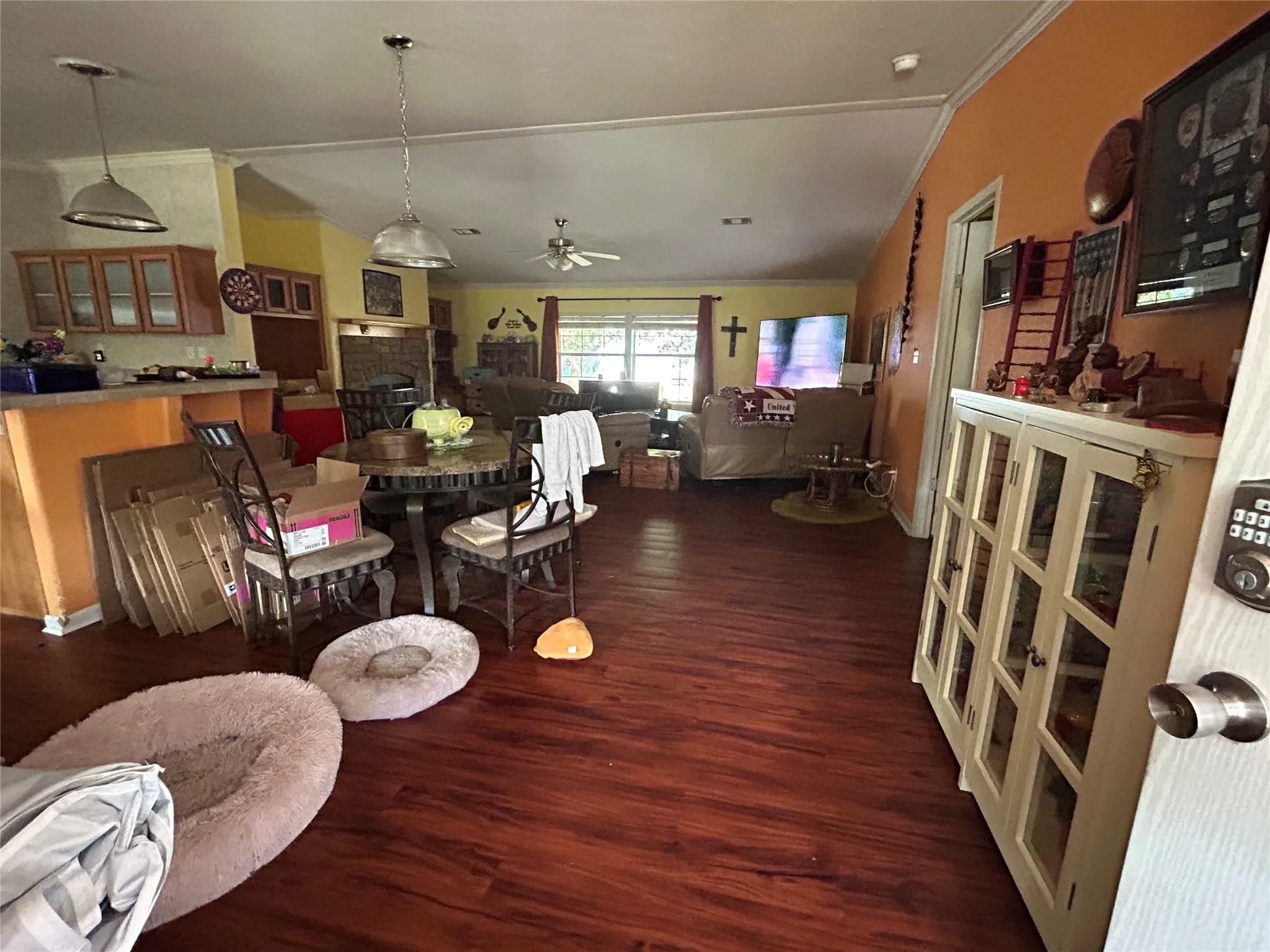 Open-concept living area with wood-finish flooring, a ceiling fan, and recessed lighting