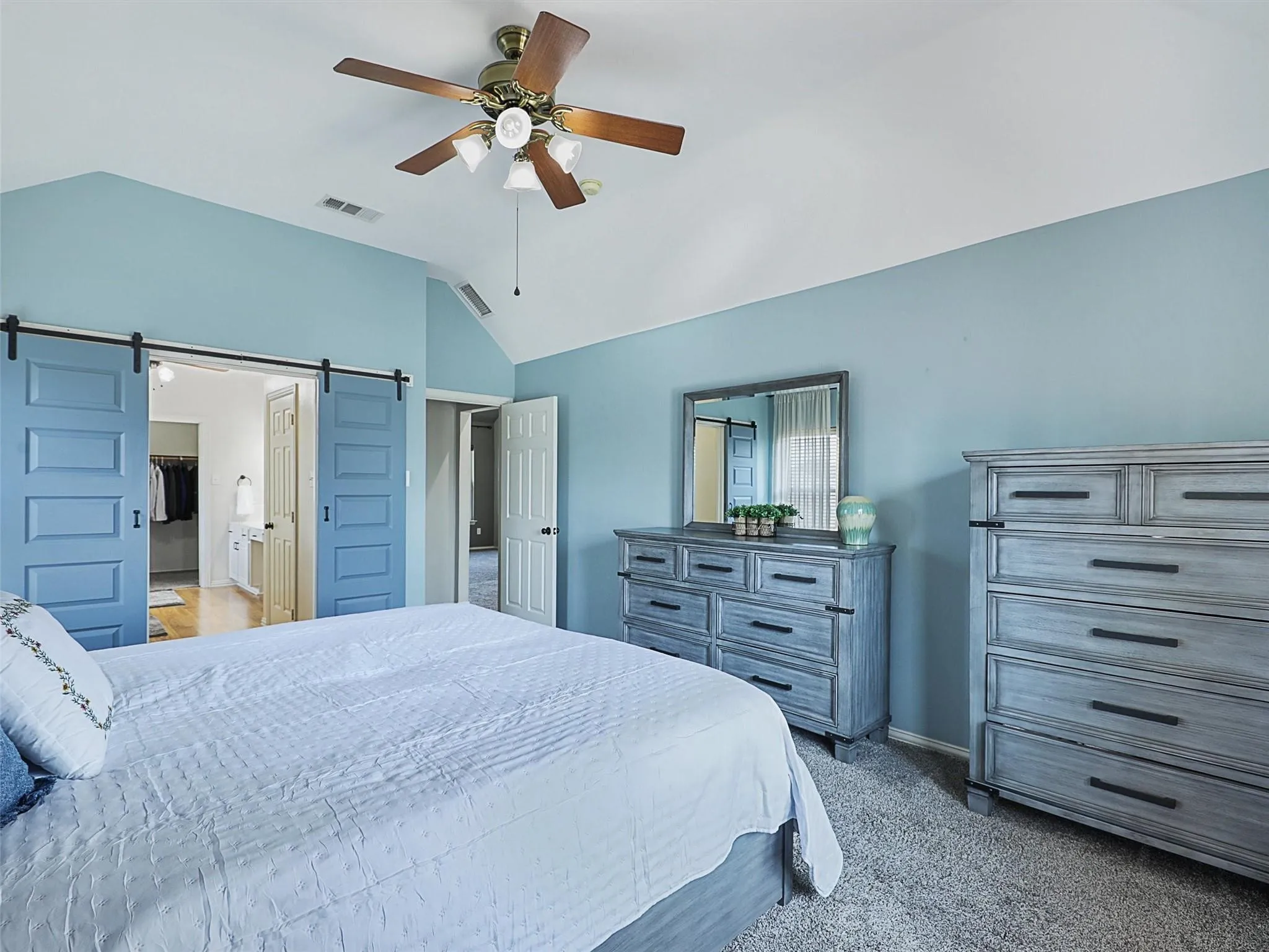 Vaulted ceiling featuring a ceiling fan with integrated lighting