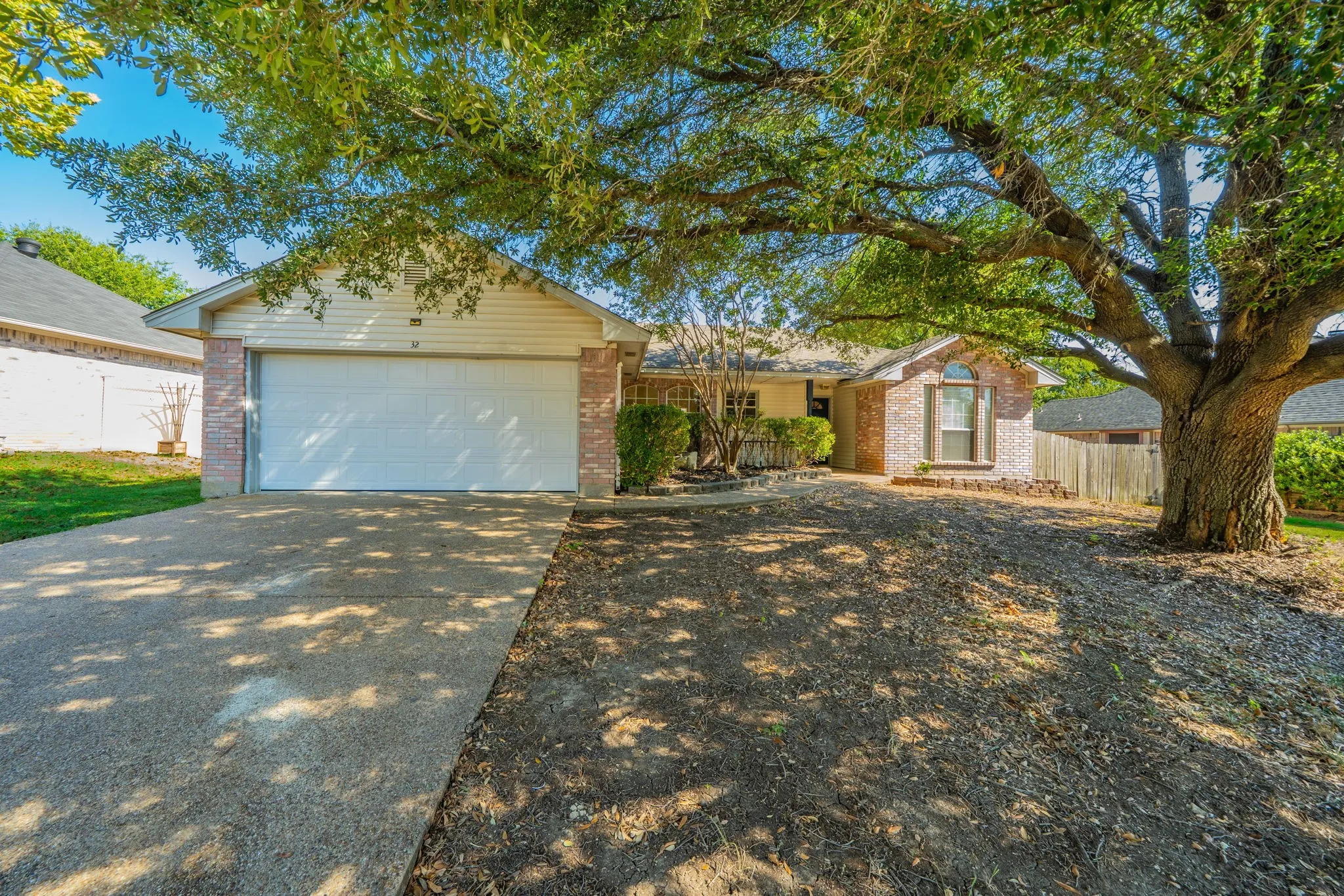 Welcome to 32 Atlantic Avenue! Beautiful front entryway with two car garage and mature trees!