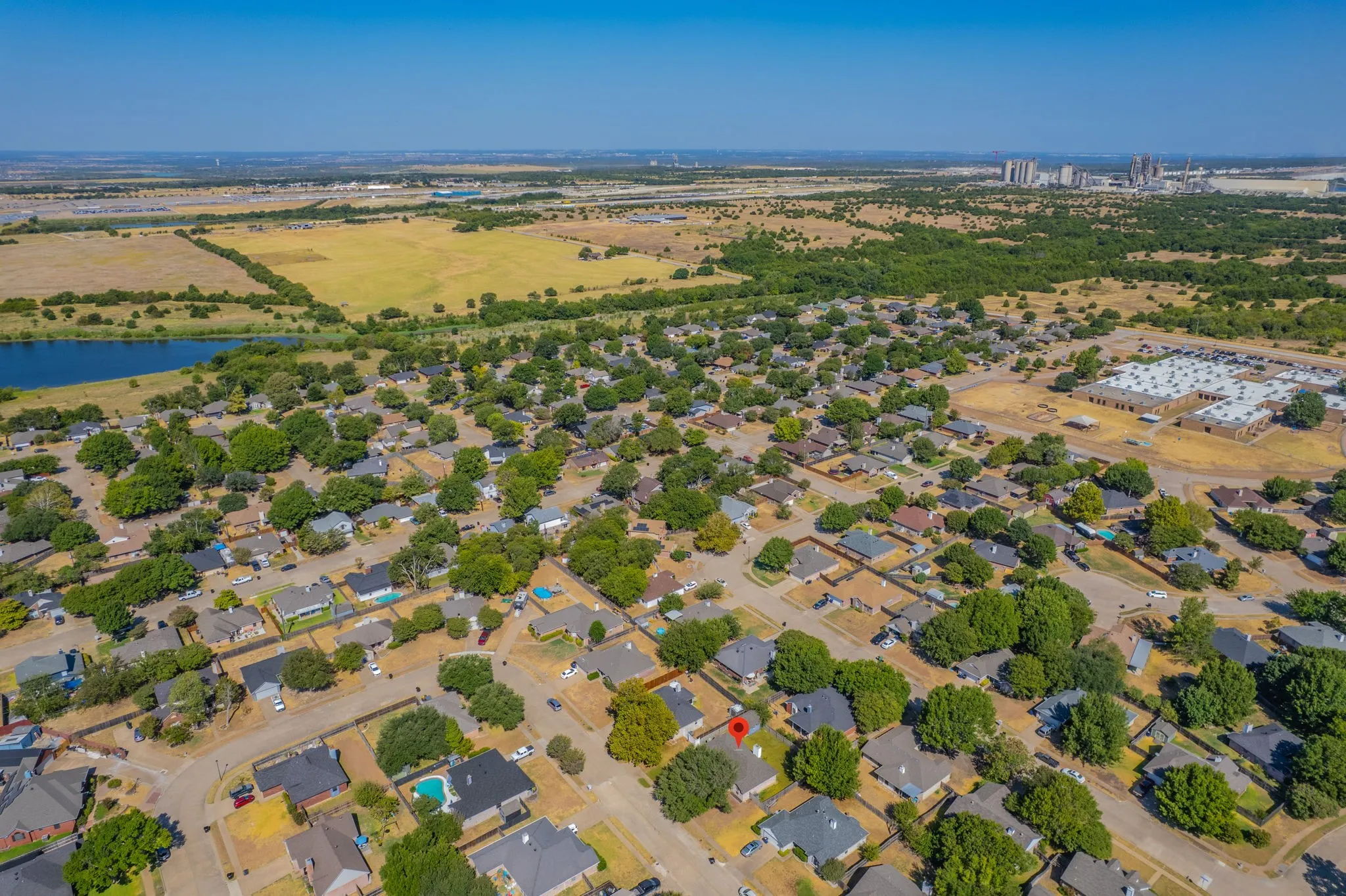Aerial view showcasing the home and spacious backyard.