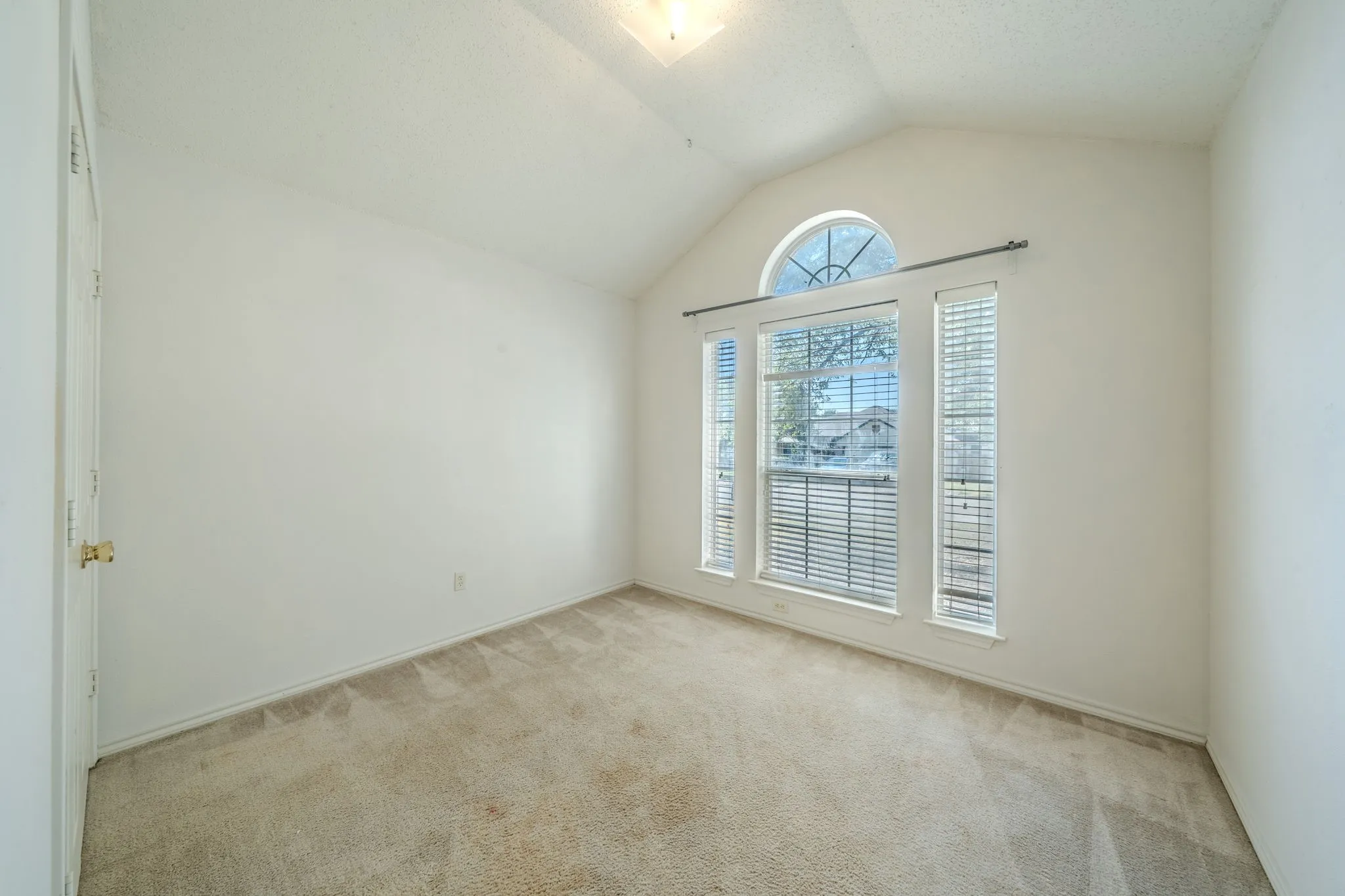 2nd bedroom featuring natural light, tall ceiling and closet.