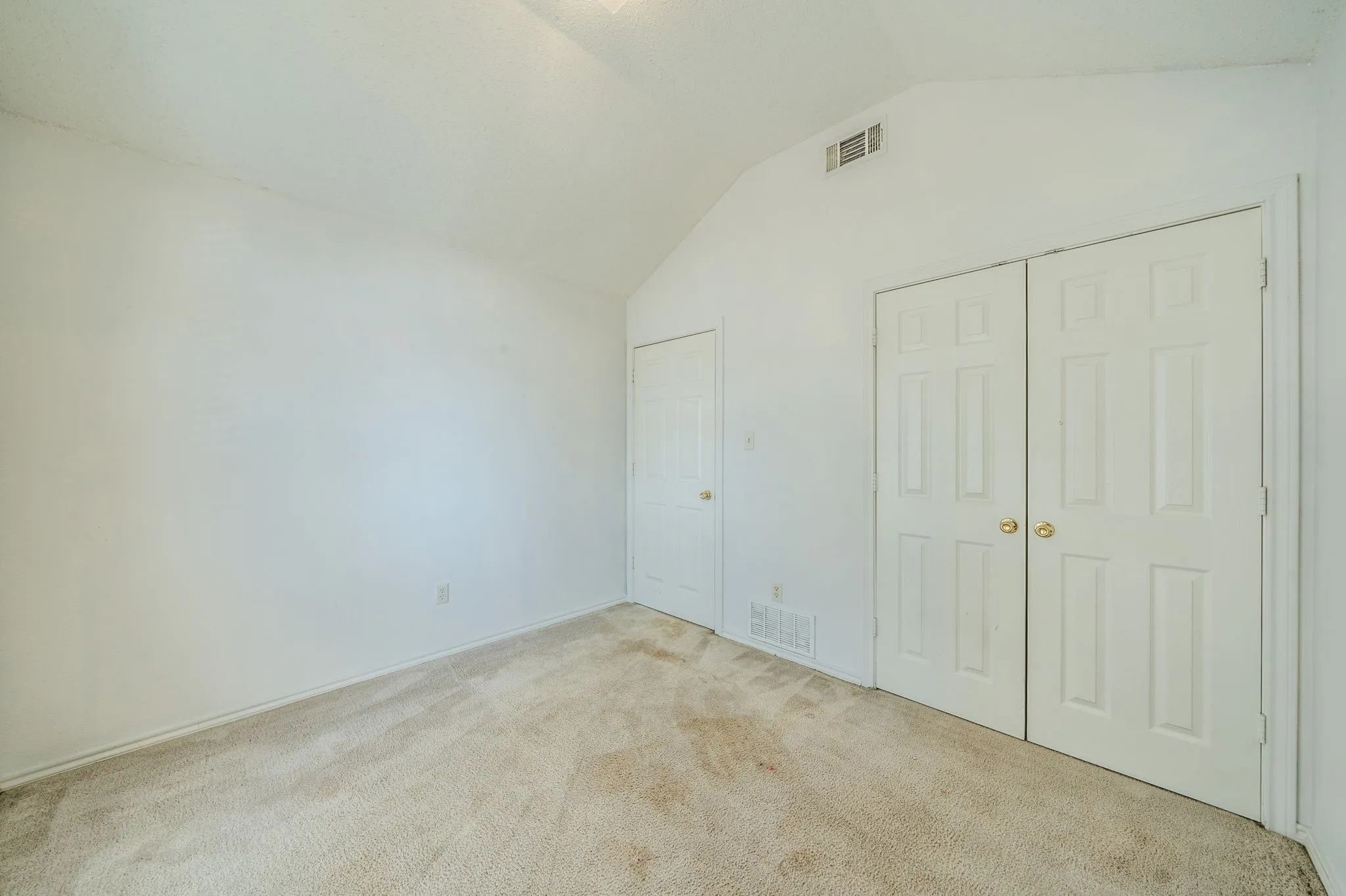 Another view of the 2nd bedroom featuring double doors to the large closet.