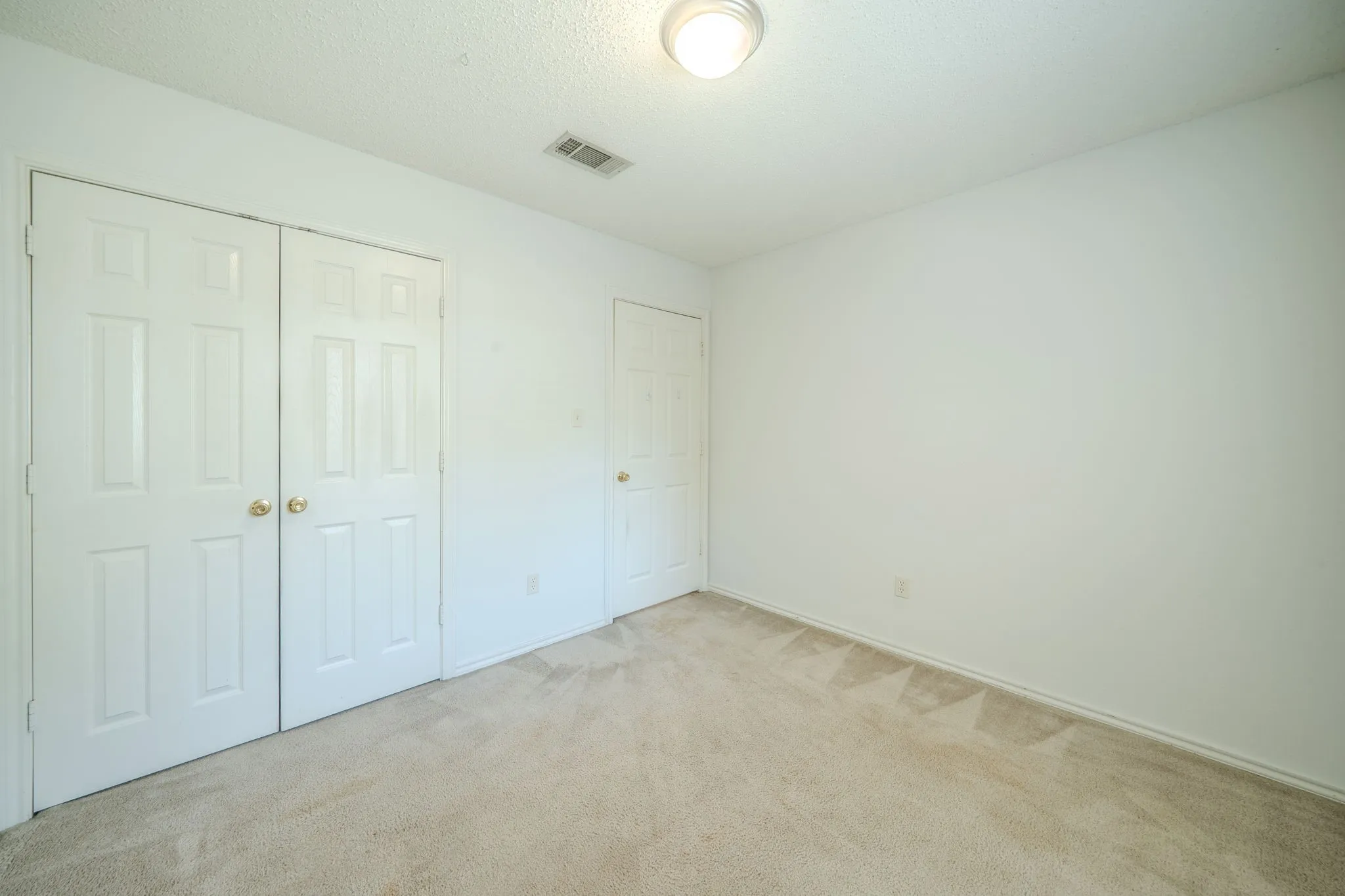 Another view of the 3rd bedroom featuring double doors to the large closet.