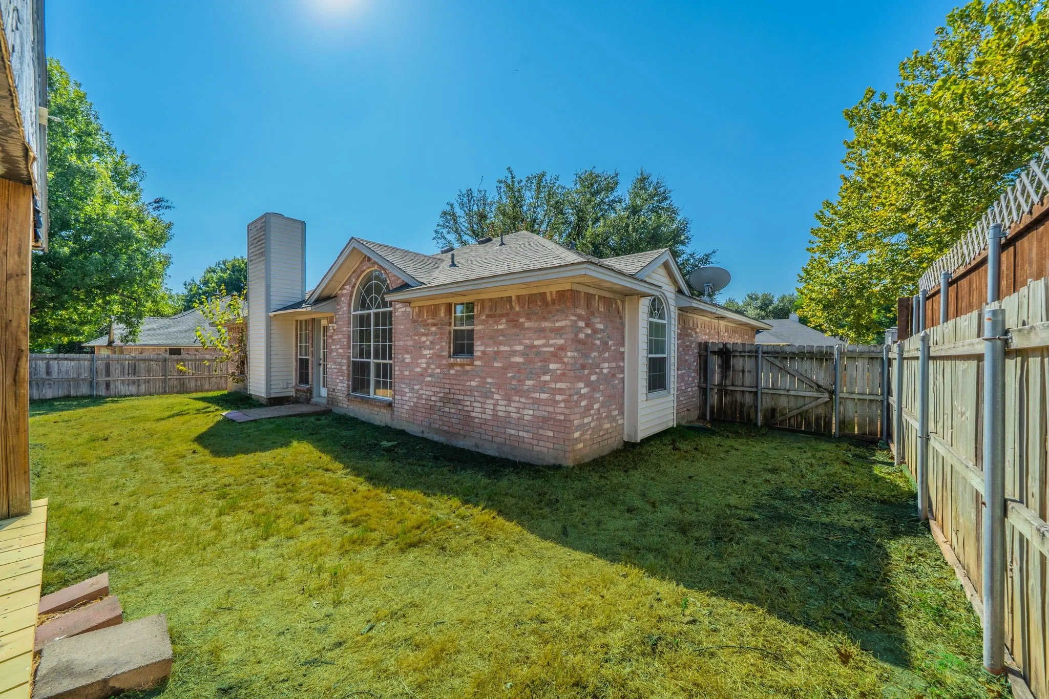Back yard view with spacious fenced yard and plenty of room for a pool, pets, kids, and PARTIES!
