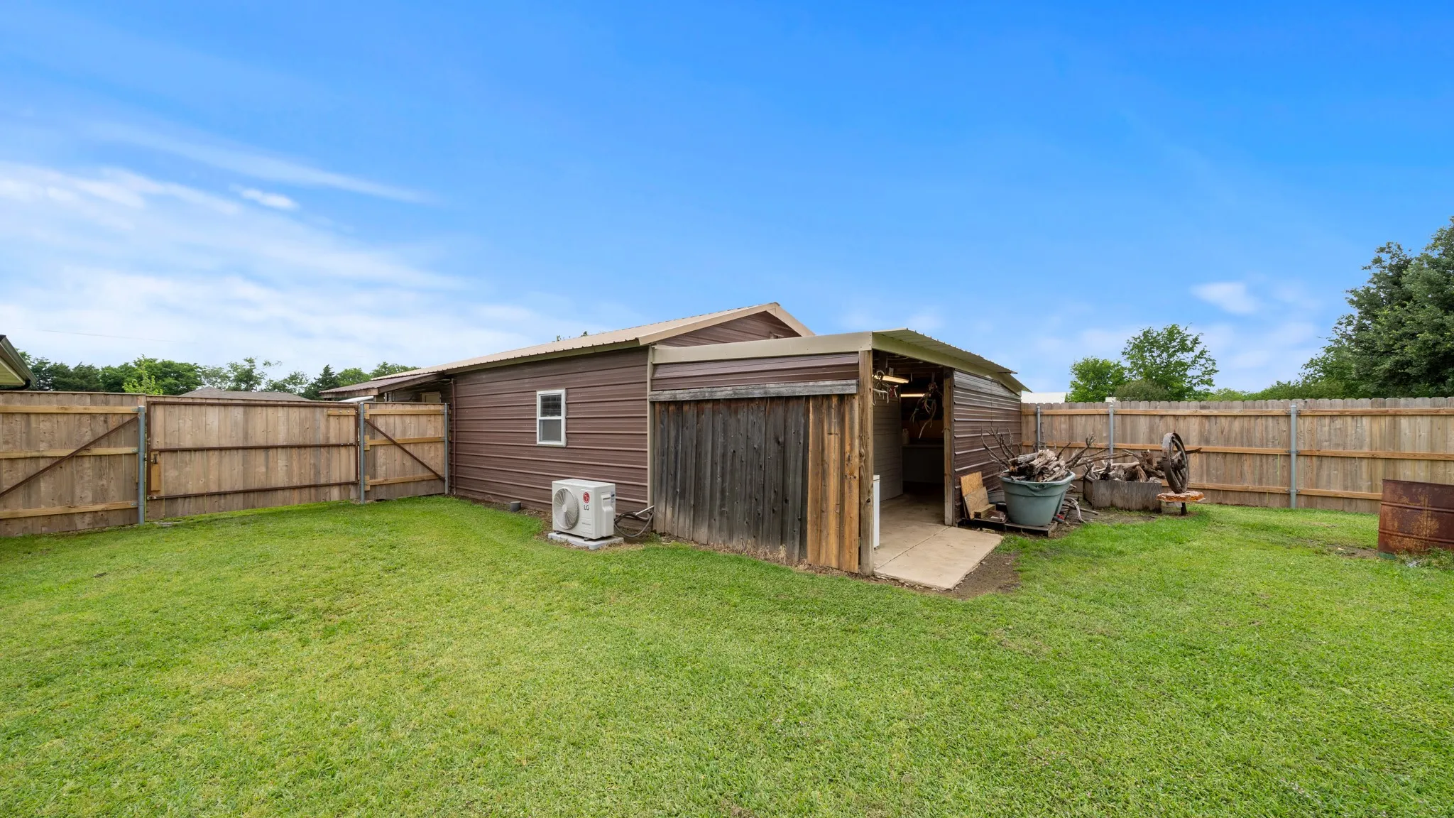 back of workshop /office Spacious backyard with mature landscaping and wooden privacy fencing throughout