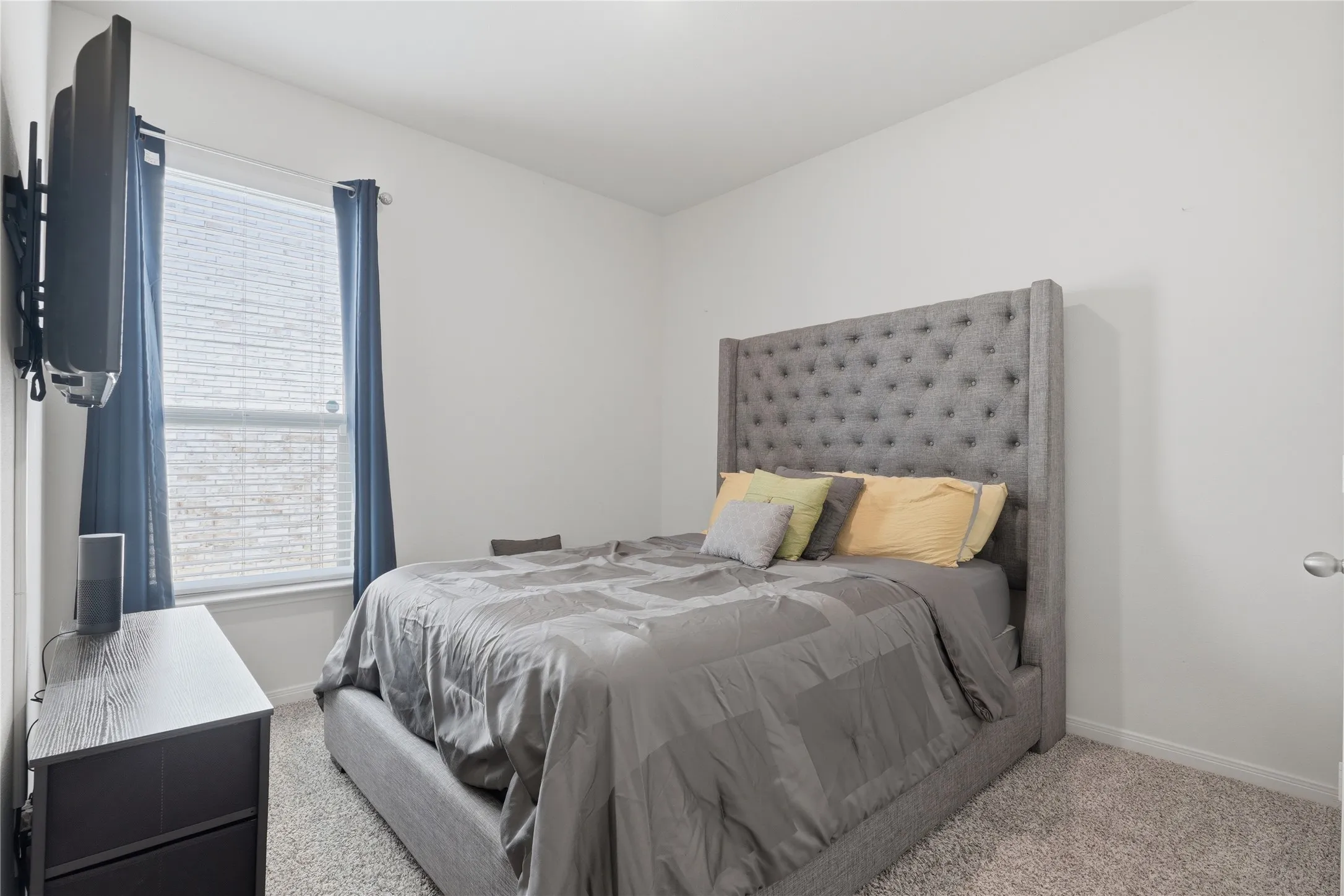 Carpeted flooring, window with blinds, and white walls