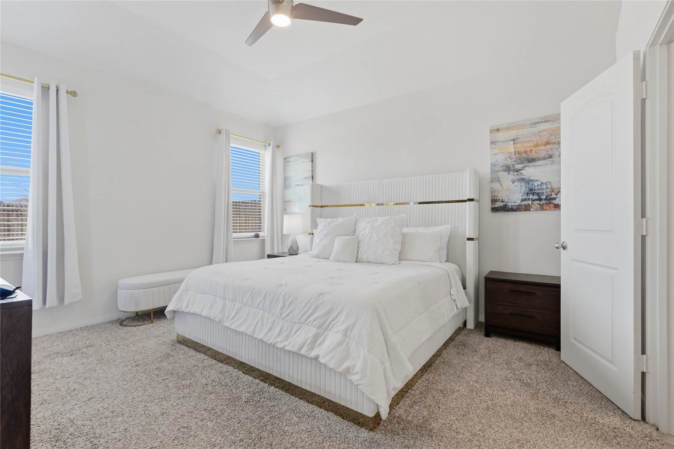 Recessed lighting, ceiling fan, two windows, wall-to-wall carpeting, and a white paneled door