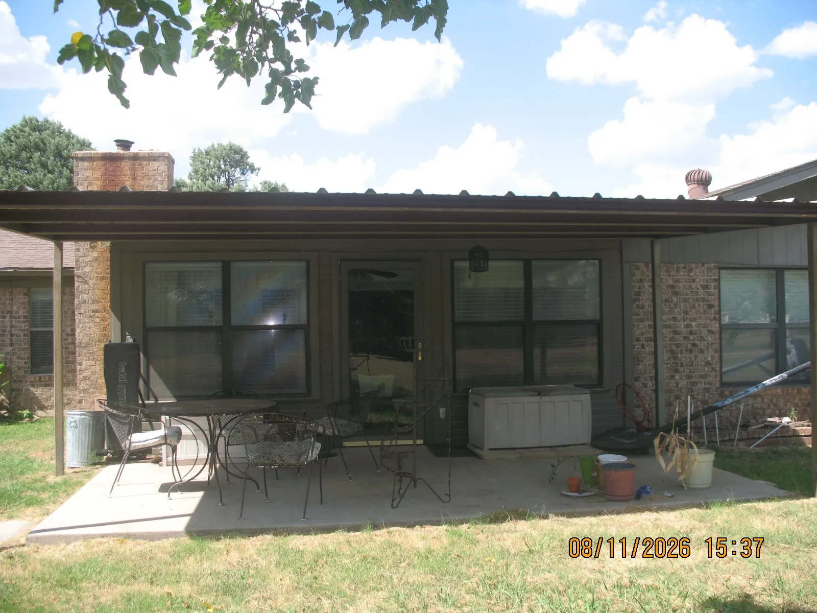 Patio featuring a concrete surface, overhead covering, and exterior access