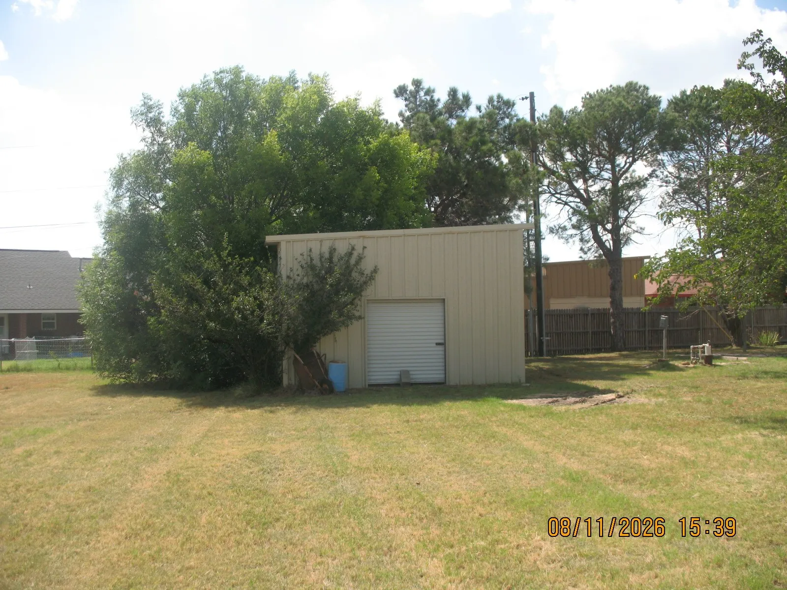 Metal utility building with roll-up door