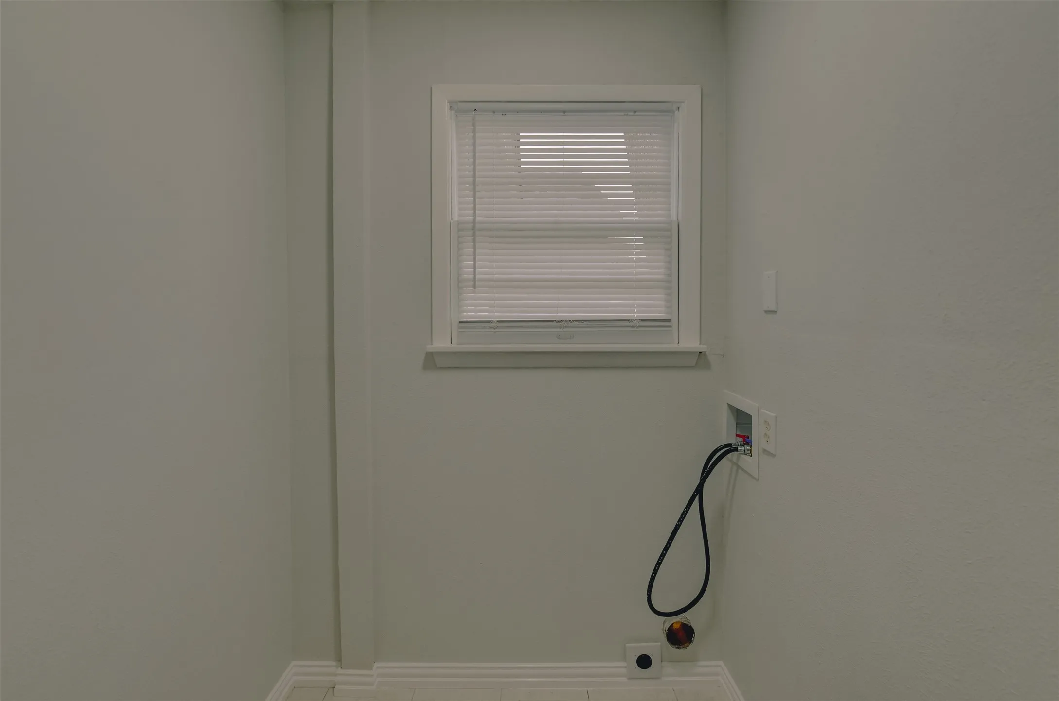 Utility area with ceramic floors, window that is great for venalation and ceramic floors