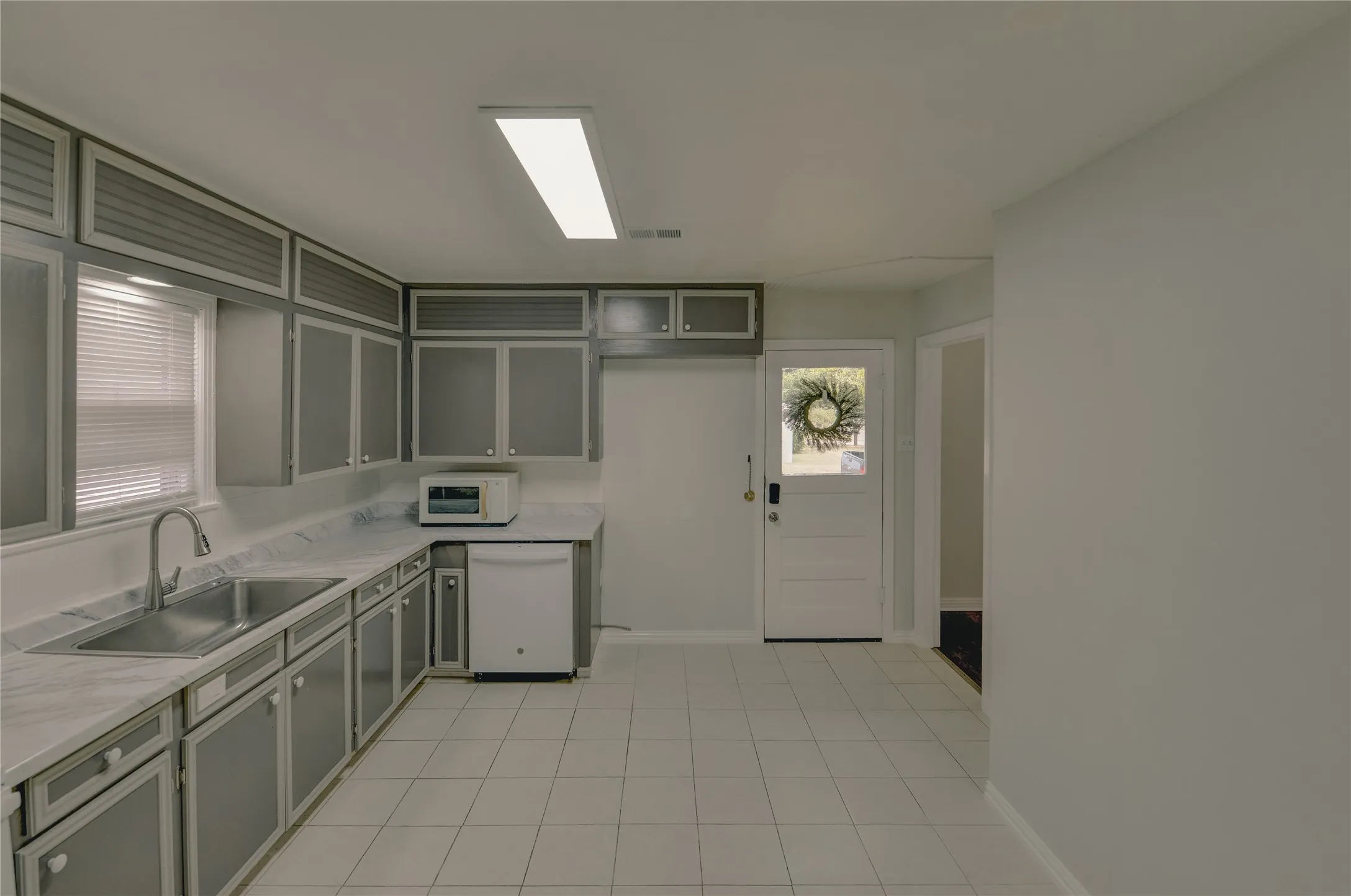 Kitchen with door that leads to the side of the home for a great second entrance.