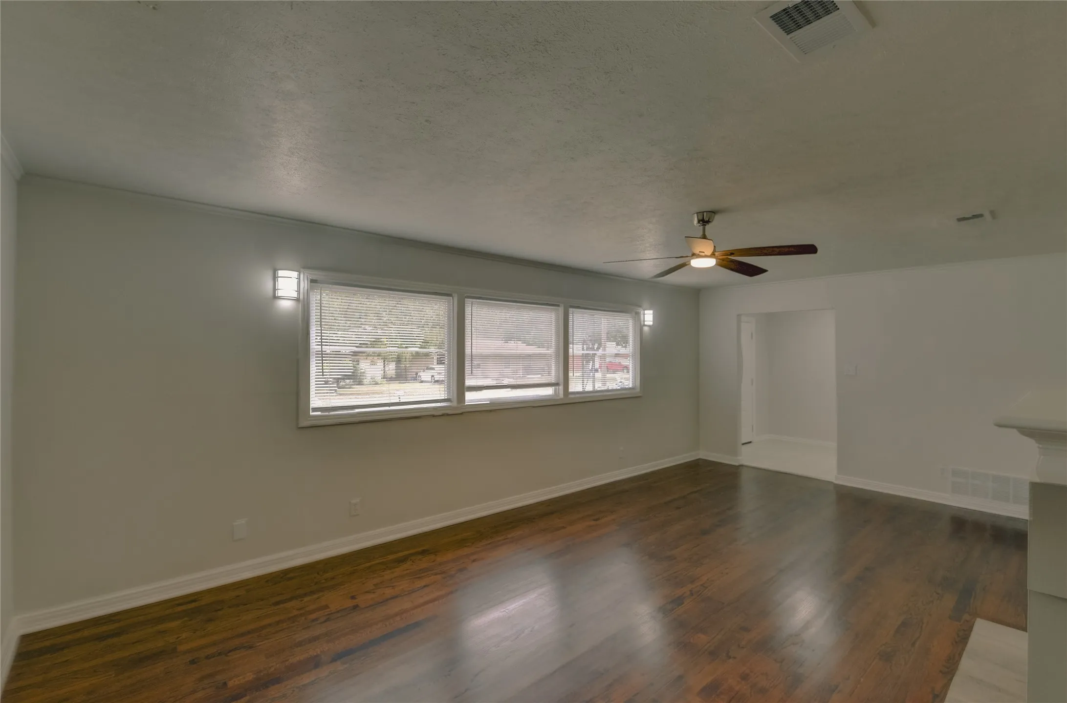 Living room with mini blinds, decorative light, hard wood floors and great floor space