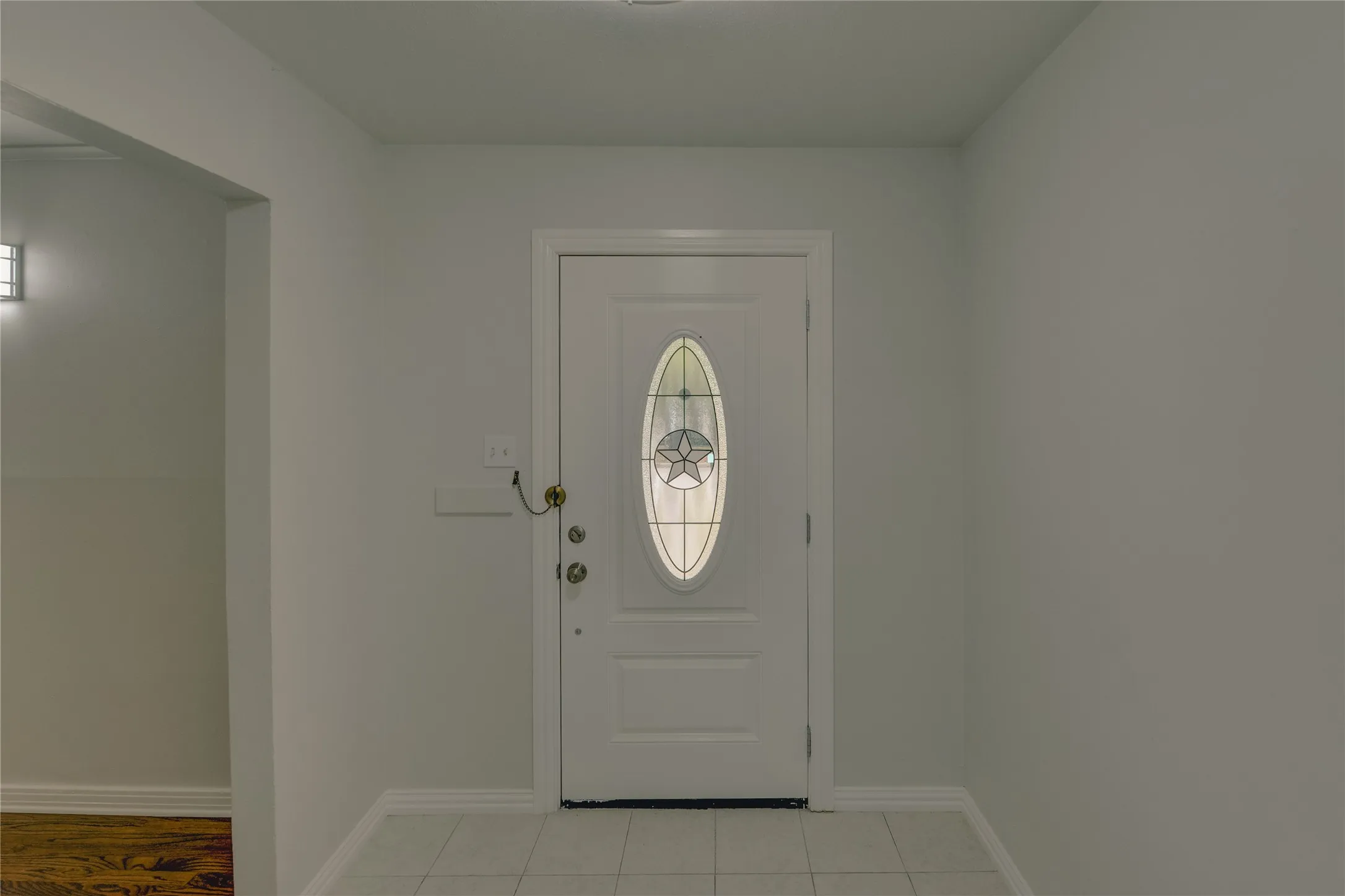 Large entry with ceramic floors, decorative door, and plenty of room for an entry table