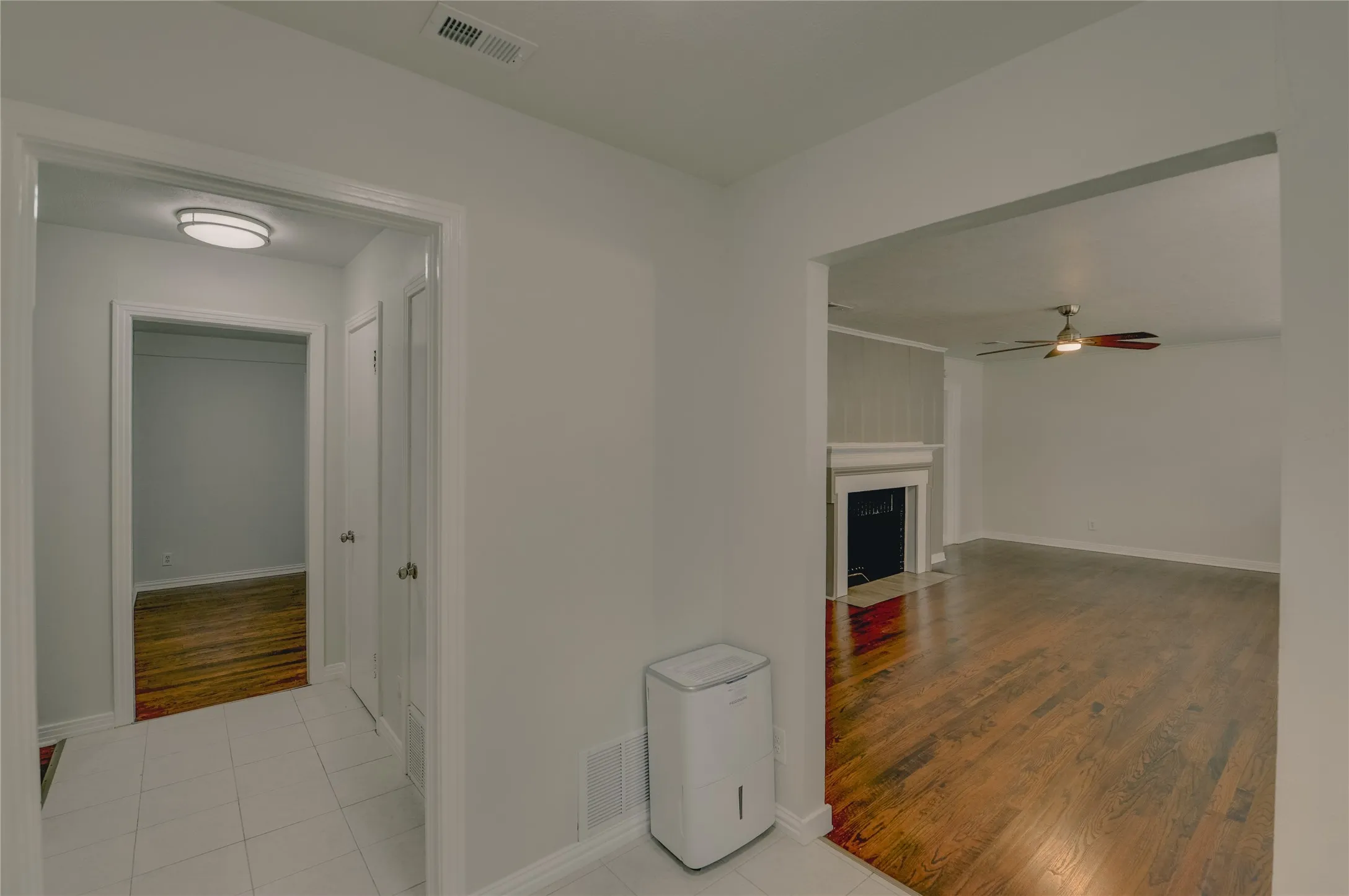 Entry hall area leading to living area and breakfast nook with ceramic flooring