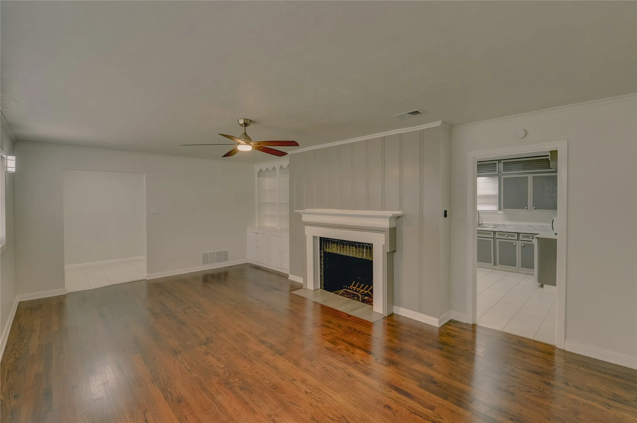Living room with view to kitchen area and an area to put a formal dining table