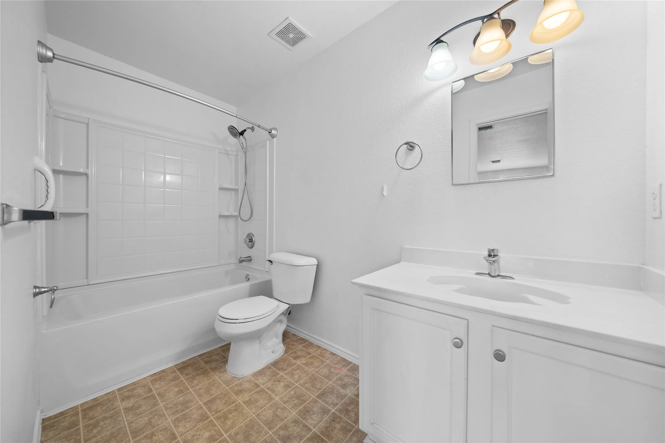 White vanity with integrated sink and chrome faucet