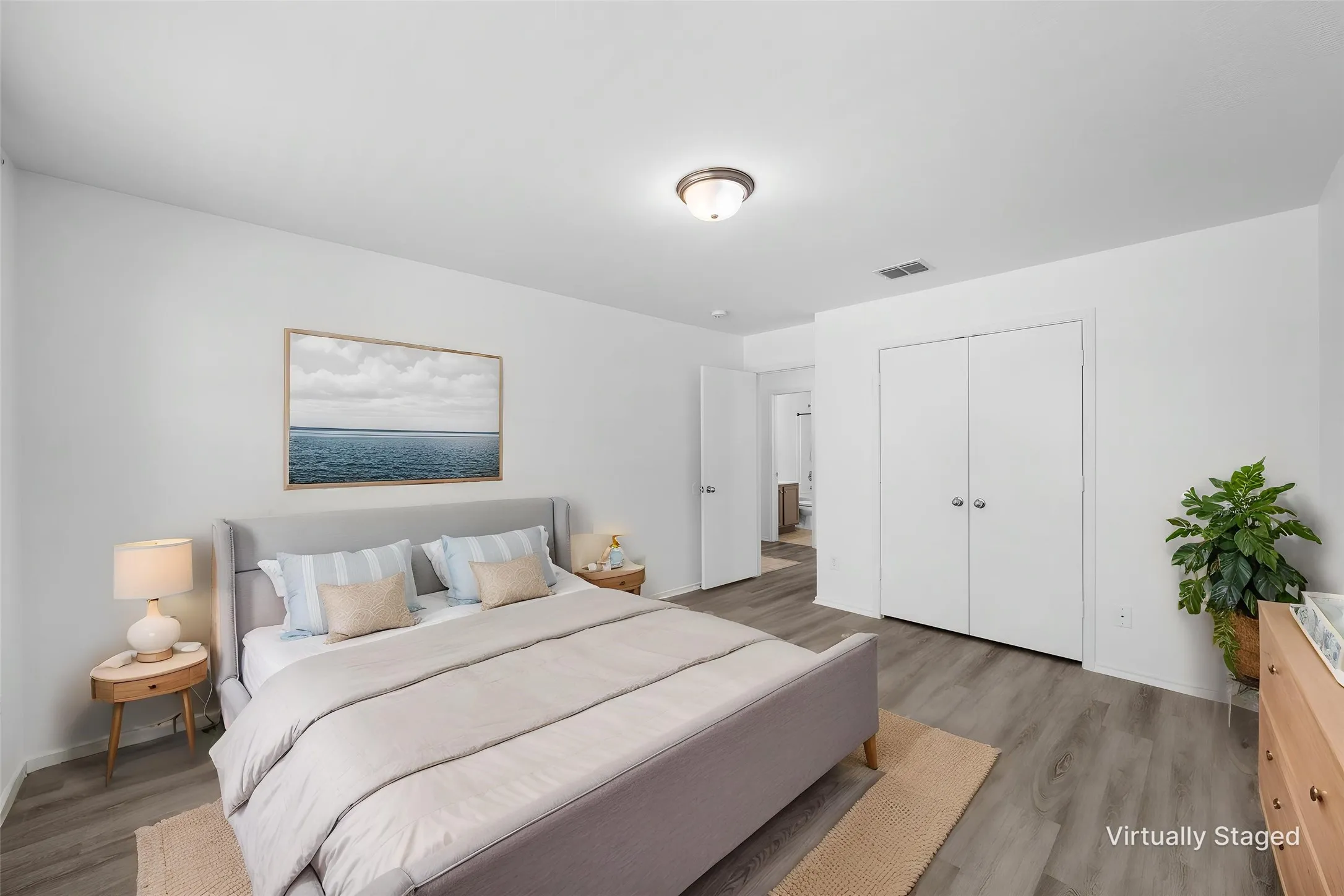 Wood-finish flooring, white walls, and a ceiling-mounted light fixture