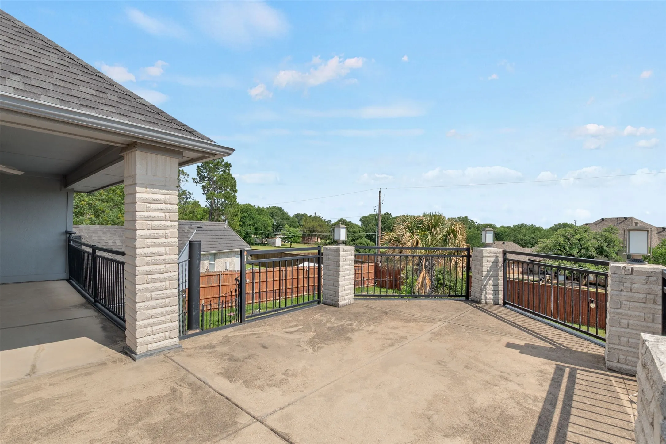 Expansive rooftop deck featuring composite decking, metal railings, and built-in seating areas