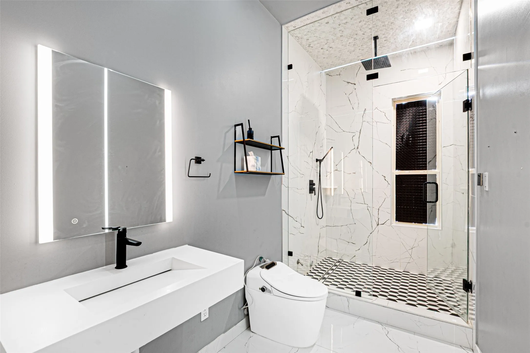 Modern bathroom featuring a floating vanity with an integrated rectangular sink and quartz countertop, paired with a matte black wall-mounted faucet