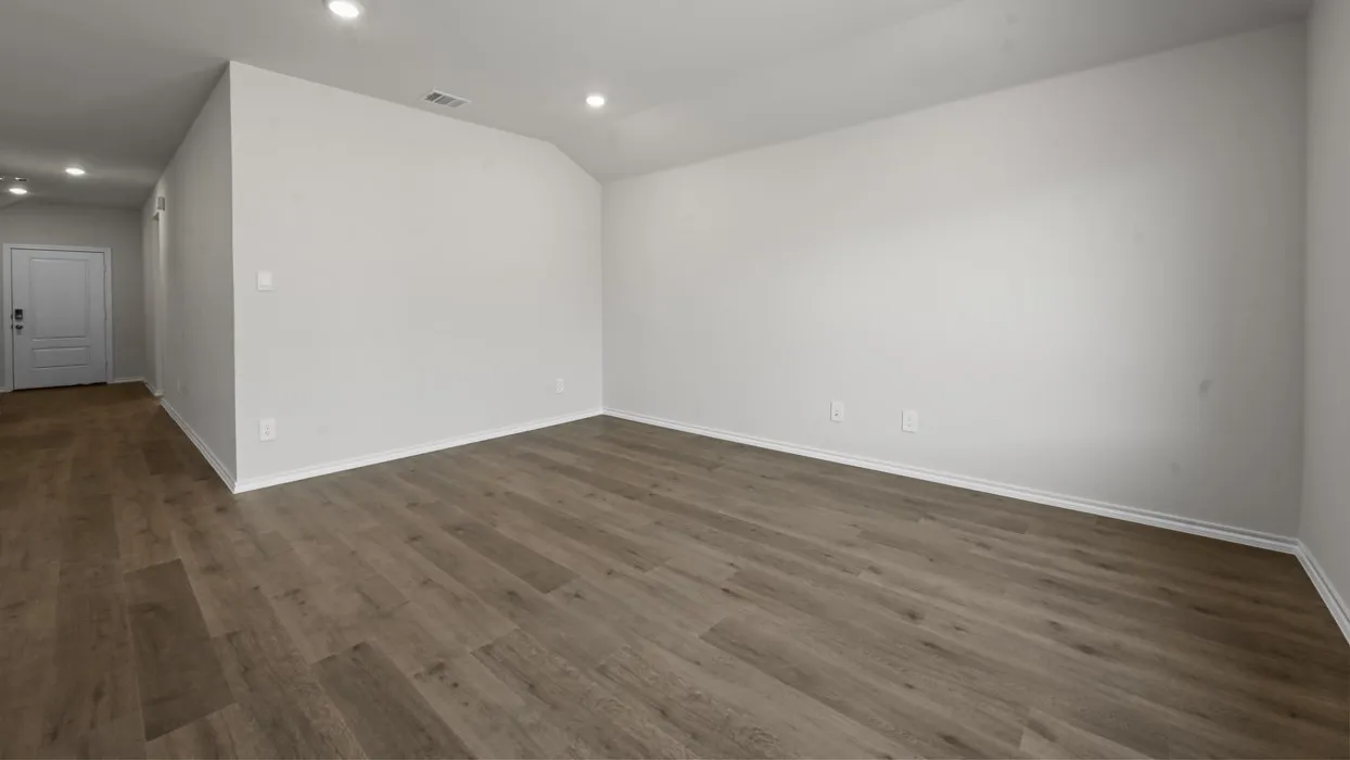 Wood-finish flooring, recessed lighting, and a white interior door