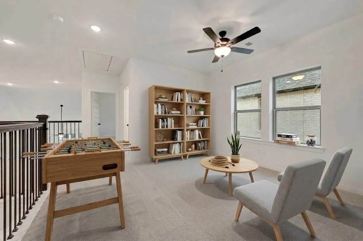 Recessed lighting, ceiling fan with light fixture, two windows, carpeted flooring, and wrought iron balusters