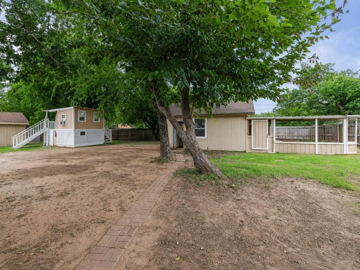 A rare property featuring a 3-bedroom, 2-bath main home, detached apartment, shop, chicken coop, and playhouse. All in one setting.