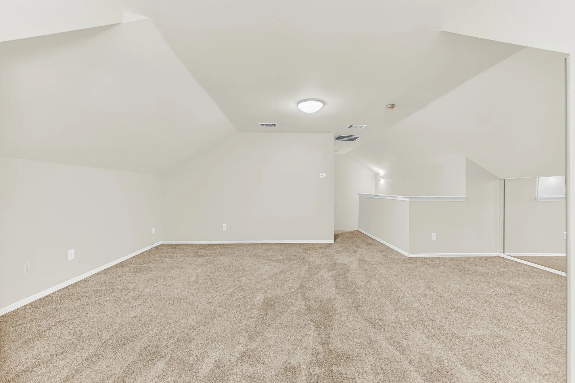 Looking toward the staircase landing, this photo demonstrates the private, secluded feel of having a standalone room occupying the entire upper level. It provides a peaceful retreat for hosting movie nights, pursuing hobbies, or relaxing in your own quiet sanctuary.