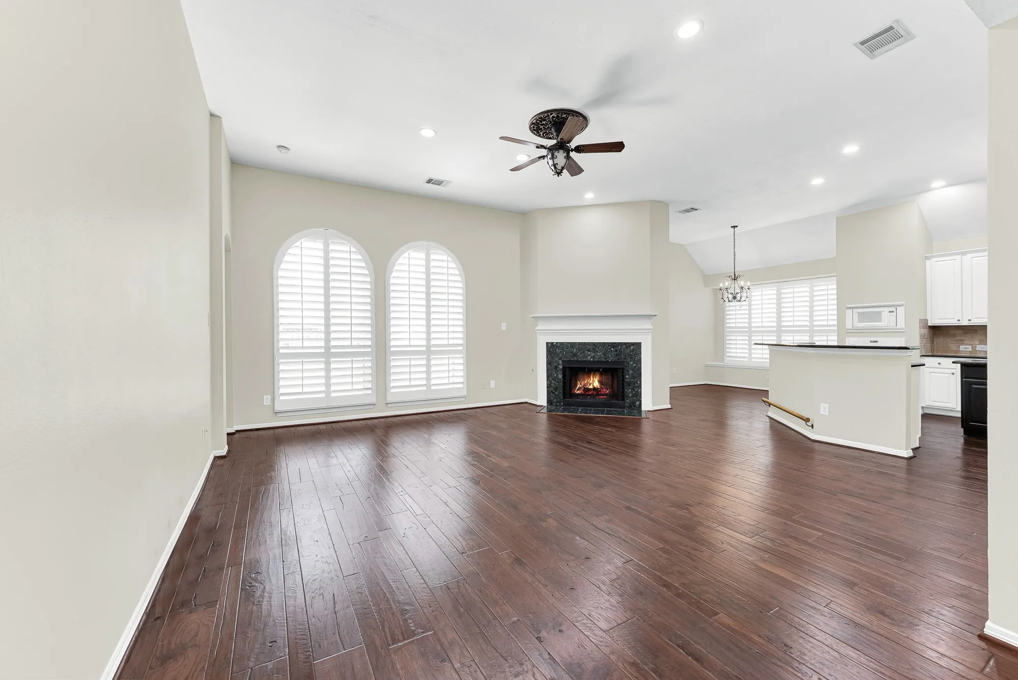 This expansive perspective highlights the open flow connecting the main living area directly to the kitchen bar and sunny breakfast nook. You can easily stay engaged with family and chat with guests while preparing meals or hosting weekend get-togethers.