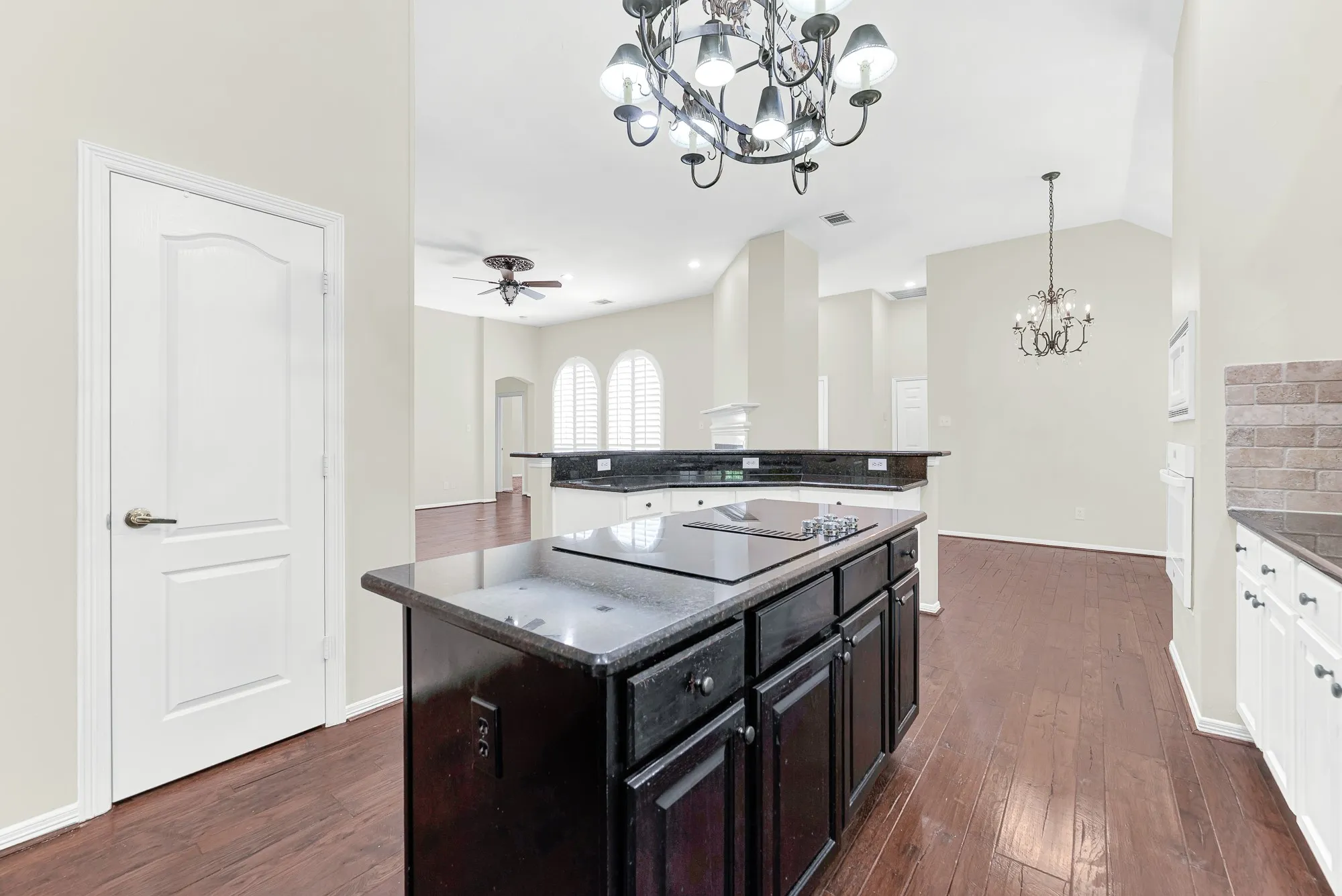 Positioned by the pantry doorway, this view captures the seamless connection from the central island straight into the main living room and dining spaces. You can stay right in the middle of the fun while hosting parties or keeping an eye on everyday activities.