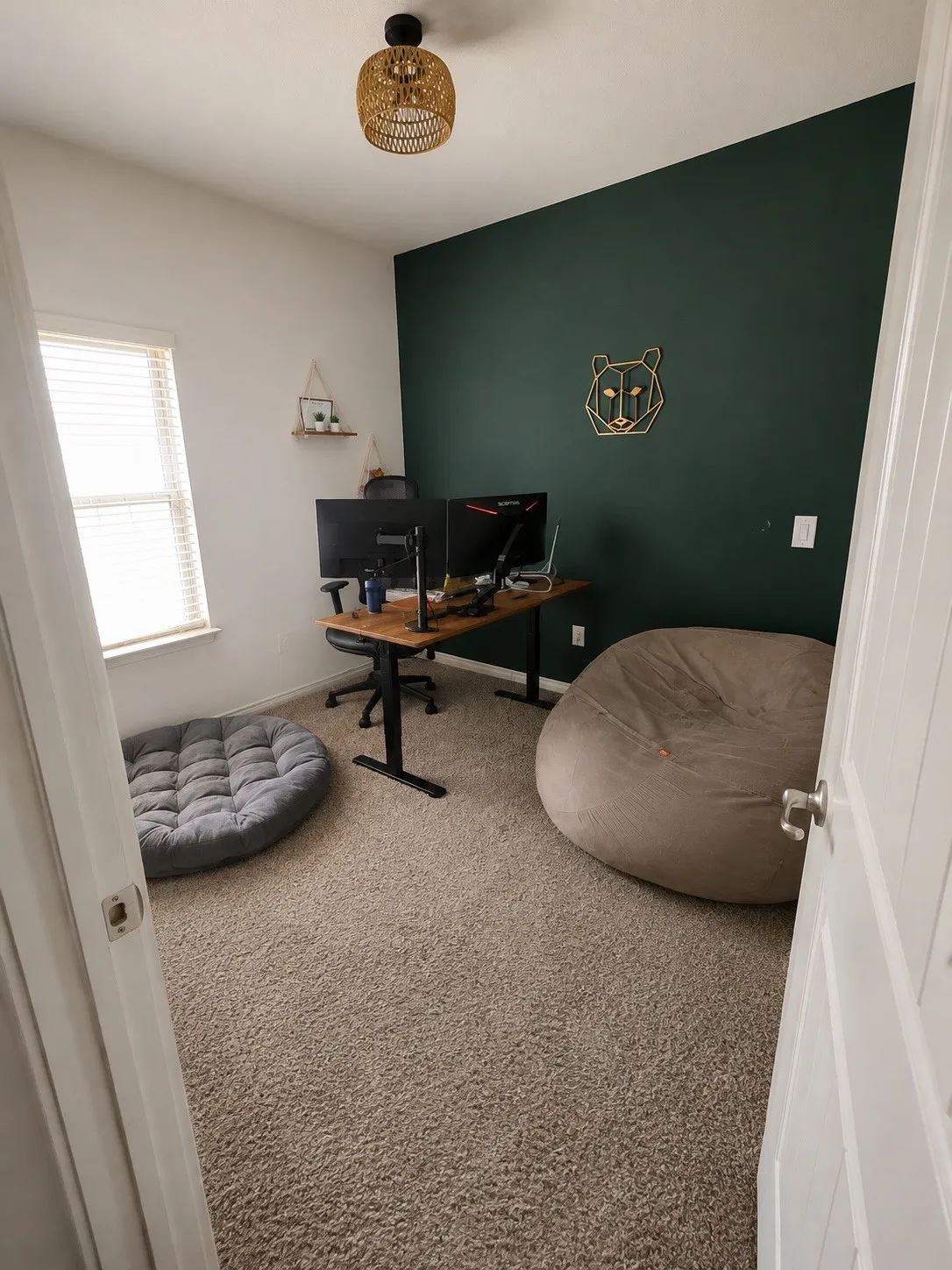 Wall-to-wall carpeting, window with blinds, recessed lighting fixture, and a feature wall in a deep green hue