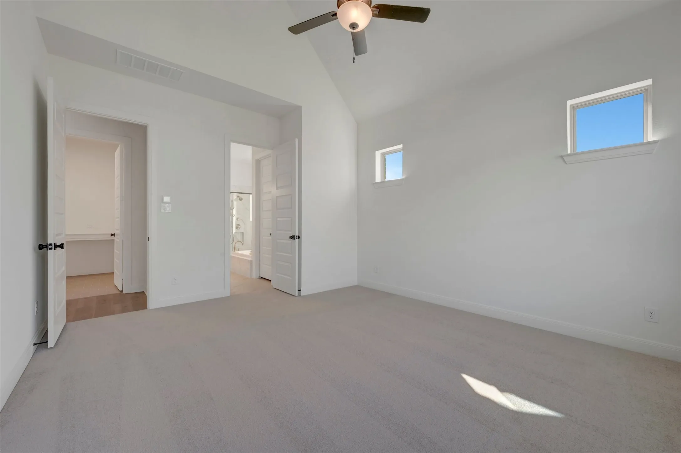 Carpeted flooring with vaulted ceiling and ceiling fan
