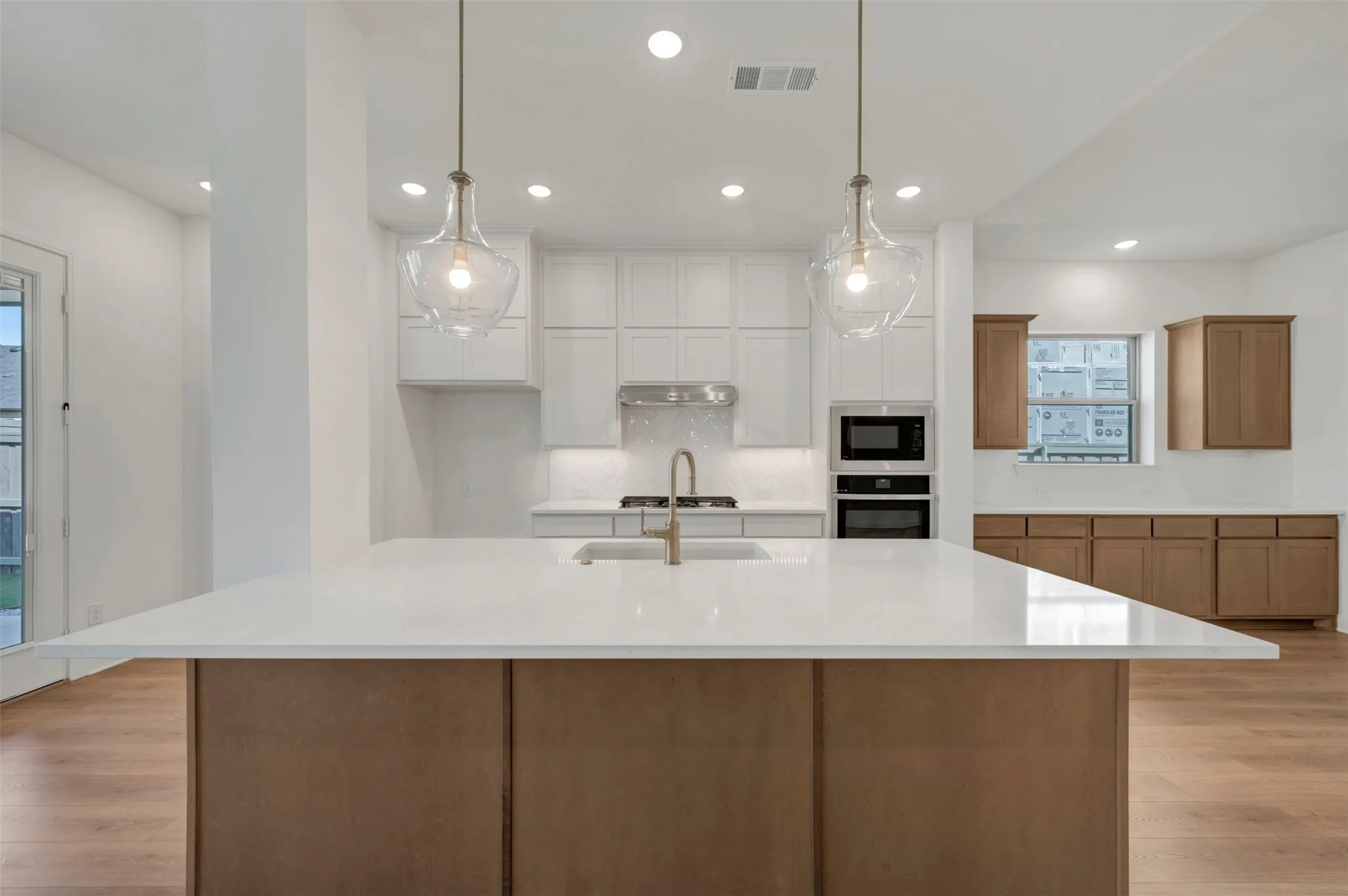 Kitchen island with a white countertop and wood-finish cabinetry