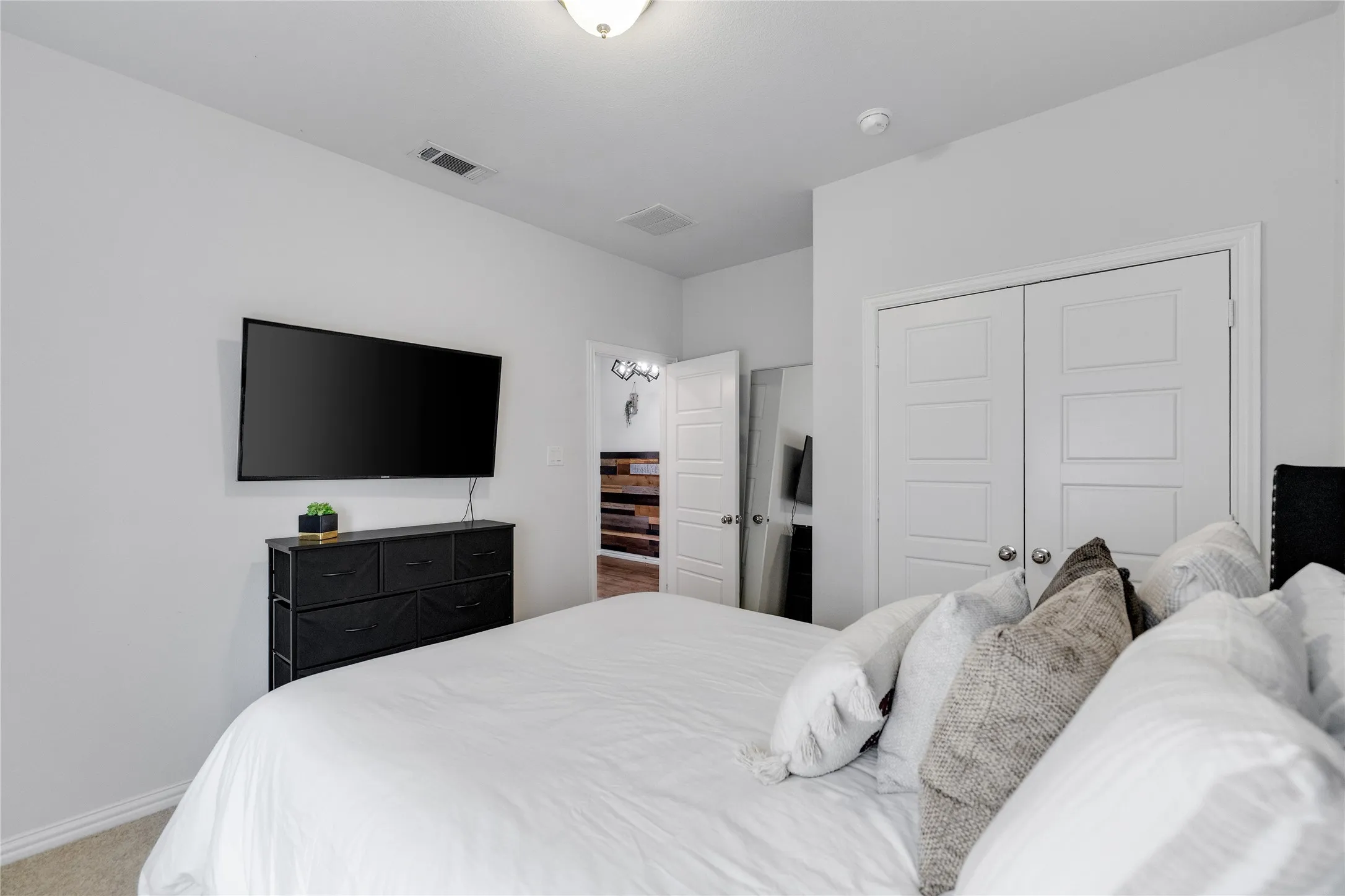 Recessed ceiling lighting, white interior doors, and carpet flooring