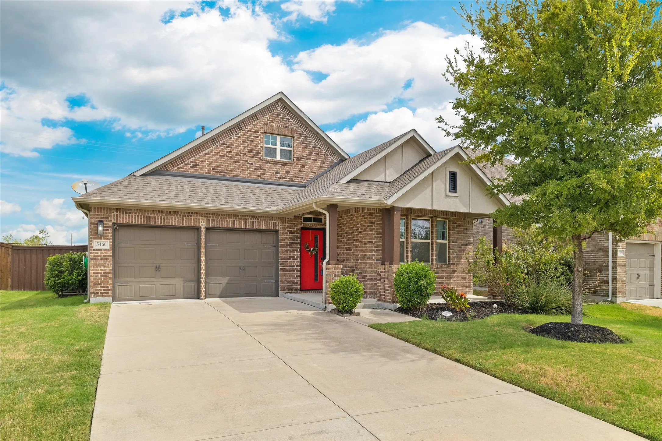 Brick exterior with a two-car garage and a concrete driveway