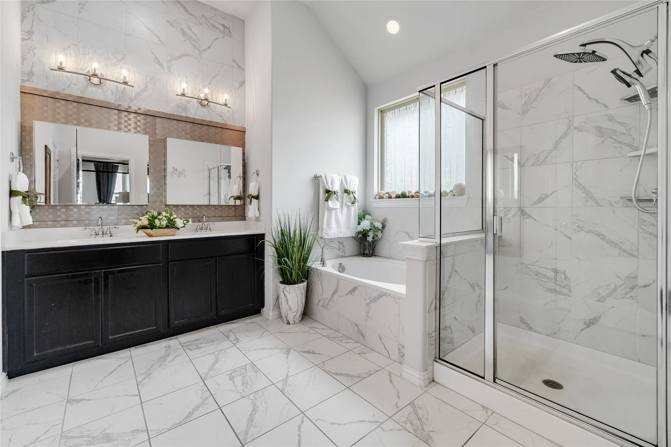 Dual vanity with dark wood cabinetry and white countertops, walk-in shower with glass enclosure, separate soaking tub, and tile flooring