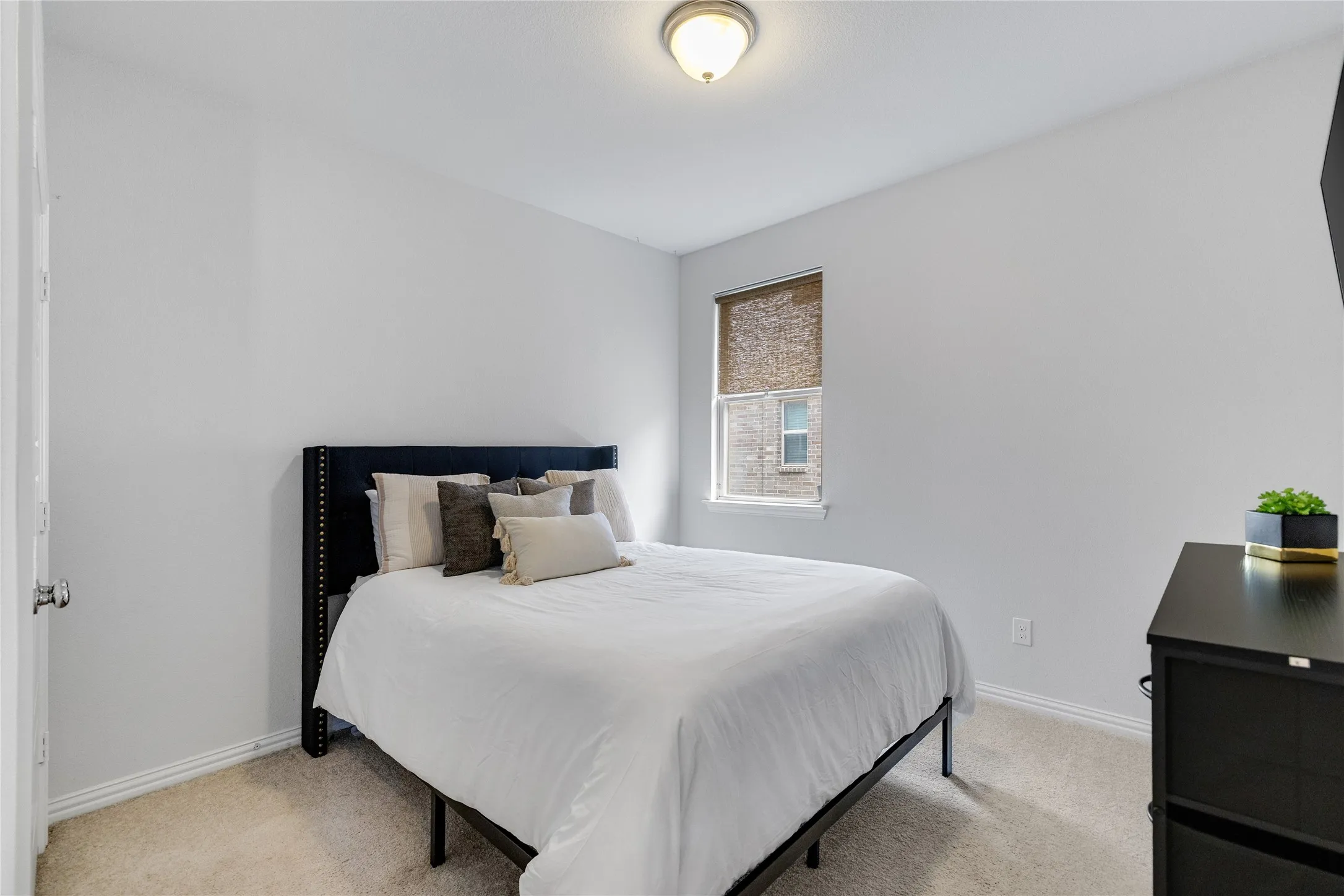Light-toned wall paint with a window featuring a roller shade