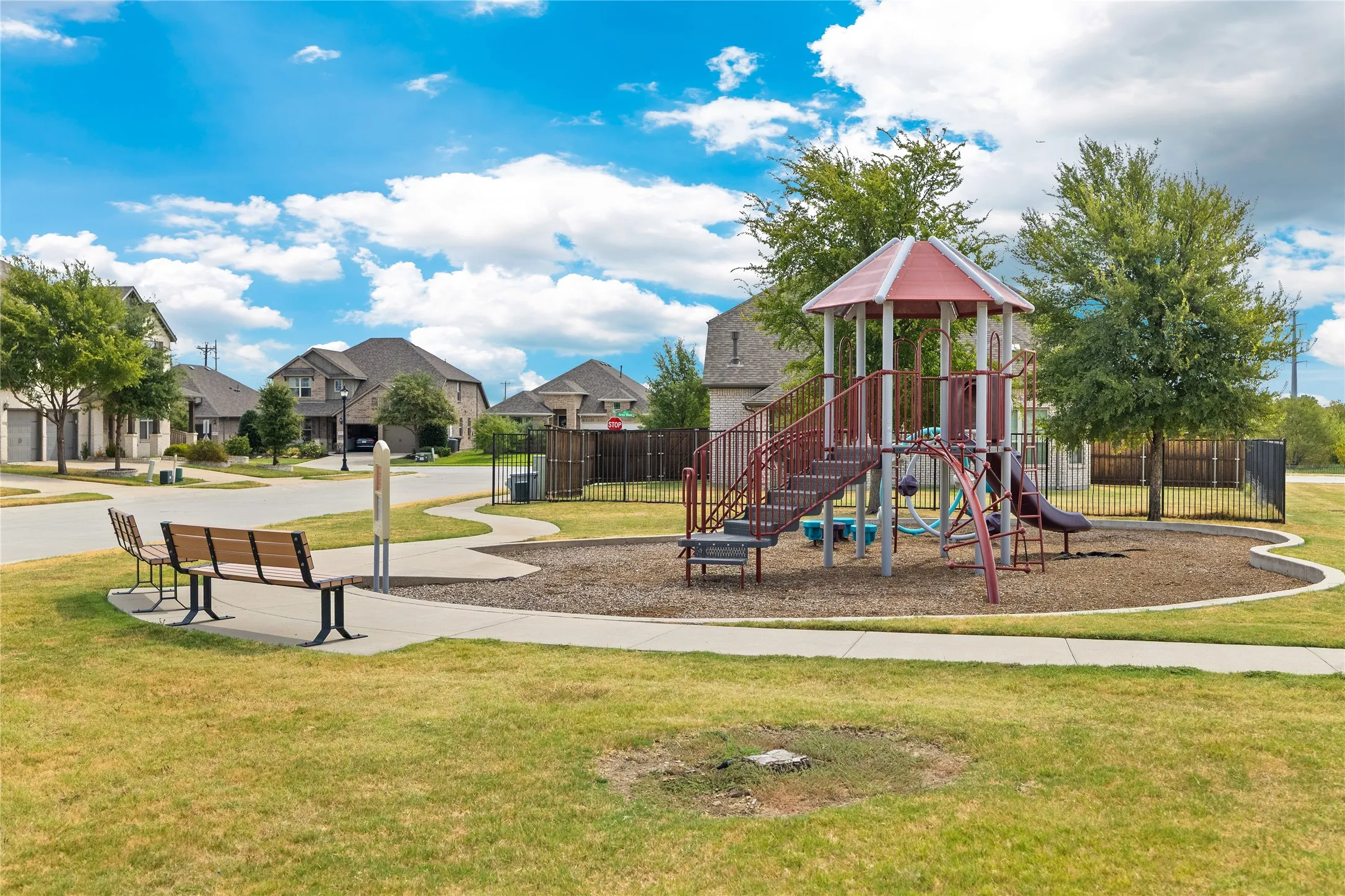 Community playground featuring a playset, slide, and climbing elements